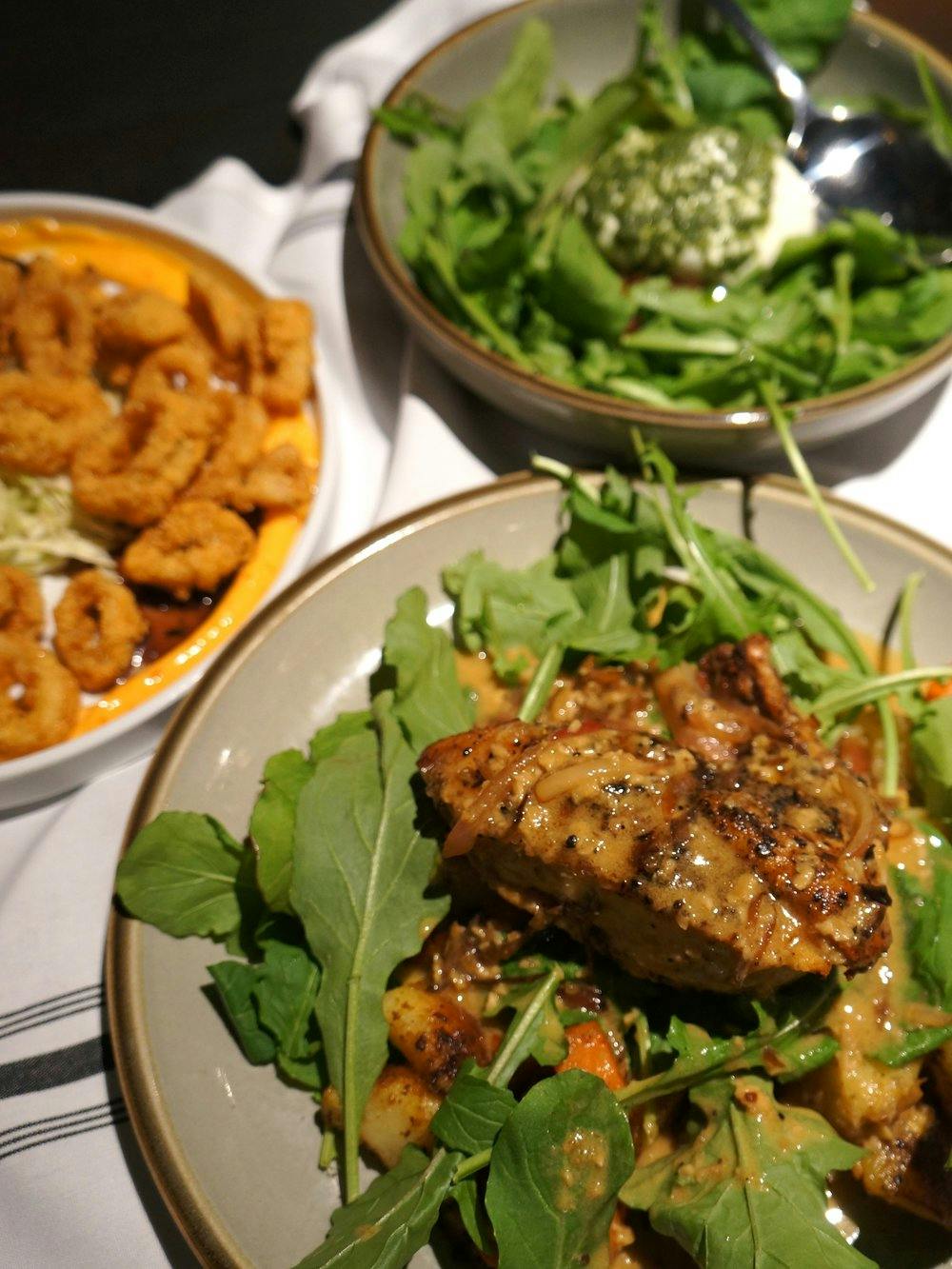 Pan-roasted chicken, calamari, and burrata at Revelry Yards