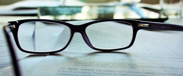 eyeglasses on top of a contract