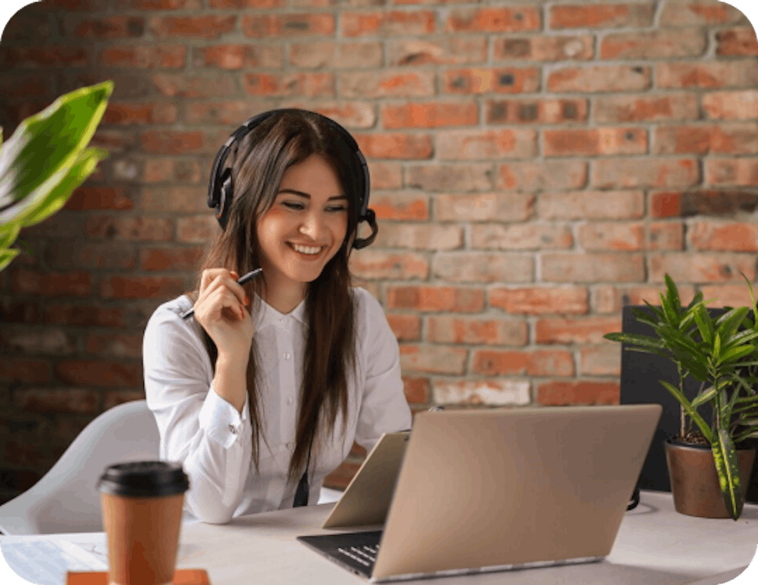 Woman at laptop with headset on