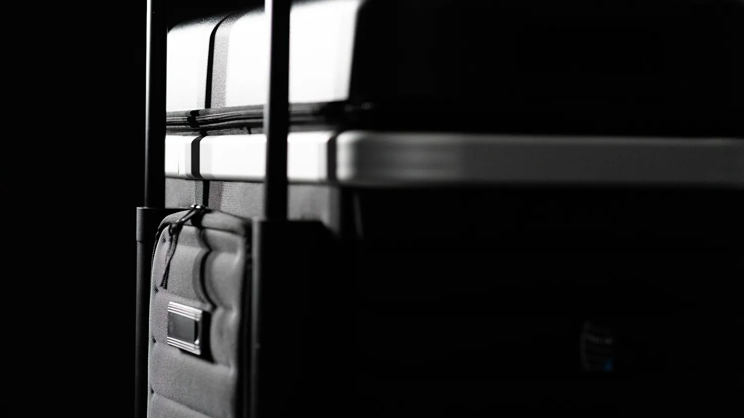 Pull Up Suitcase in black - detailed back view with trolley handle