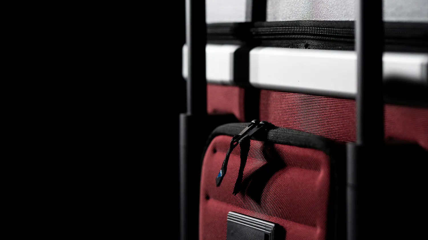 Pull Up Suitcase in red - detailed back view with trolley handle