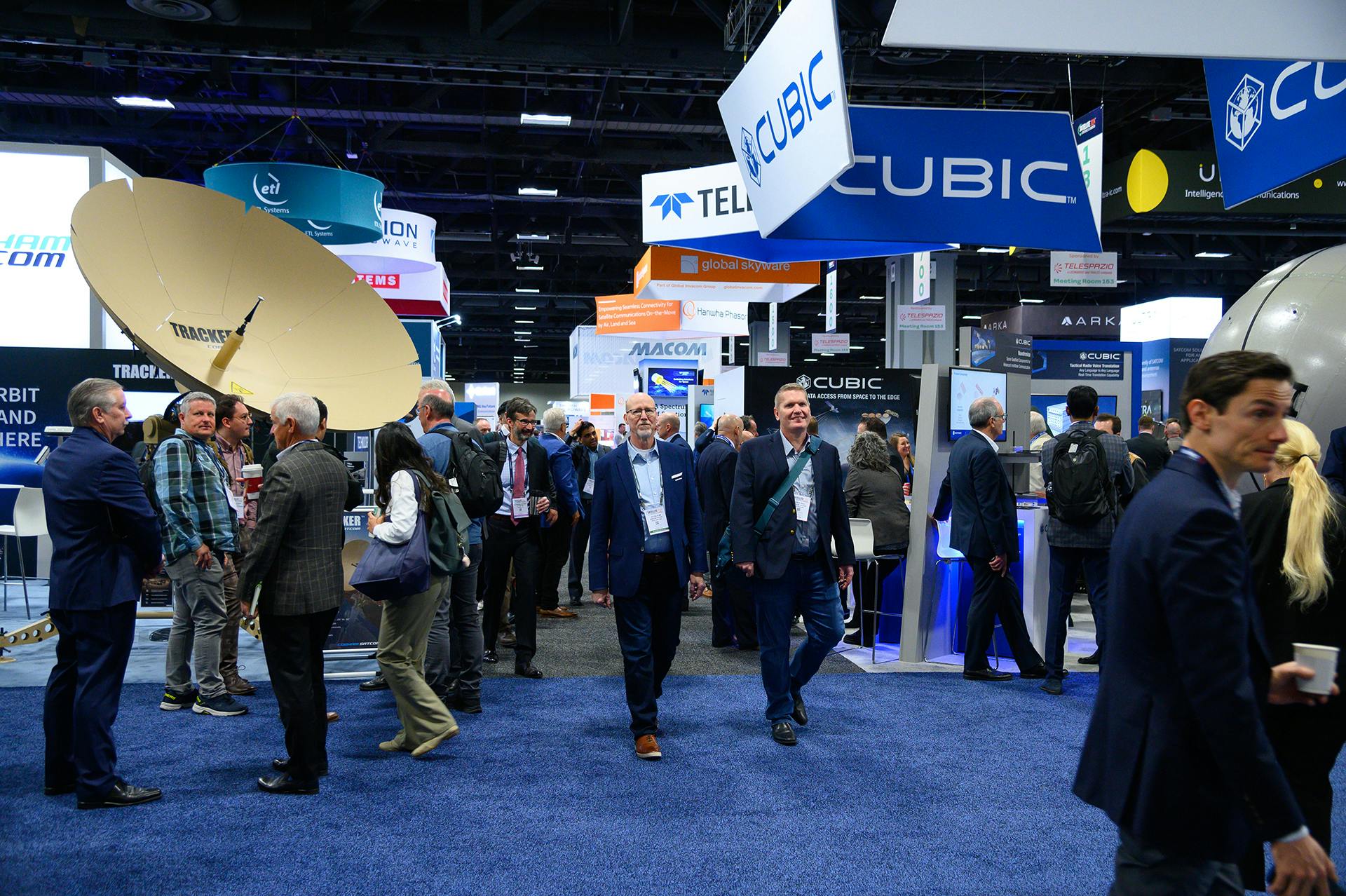 people in suits at a satcom convention
