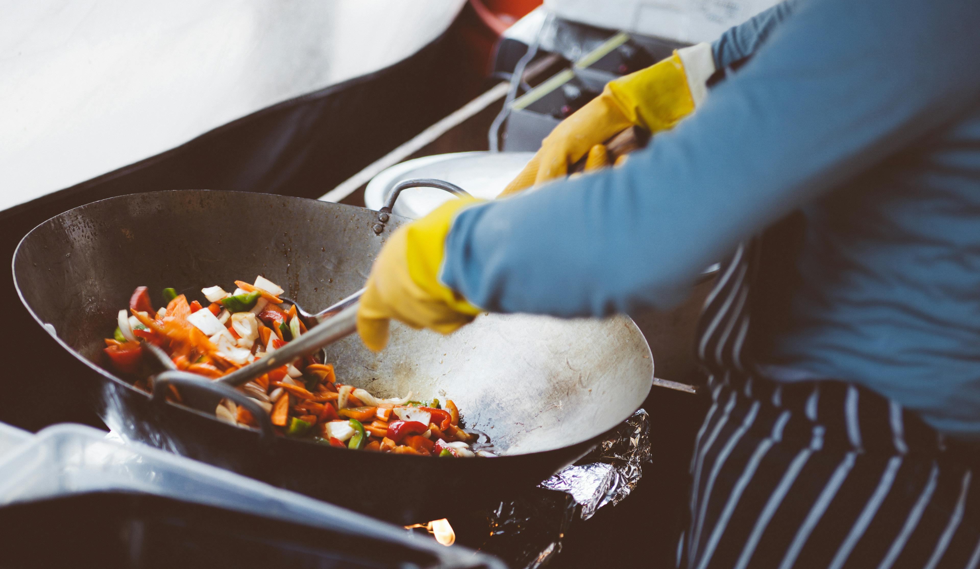 Cuisine being prepared in a Thai food truck. 