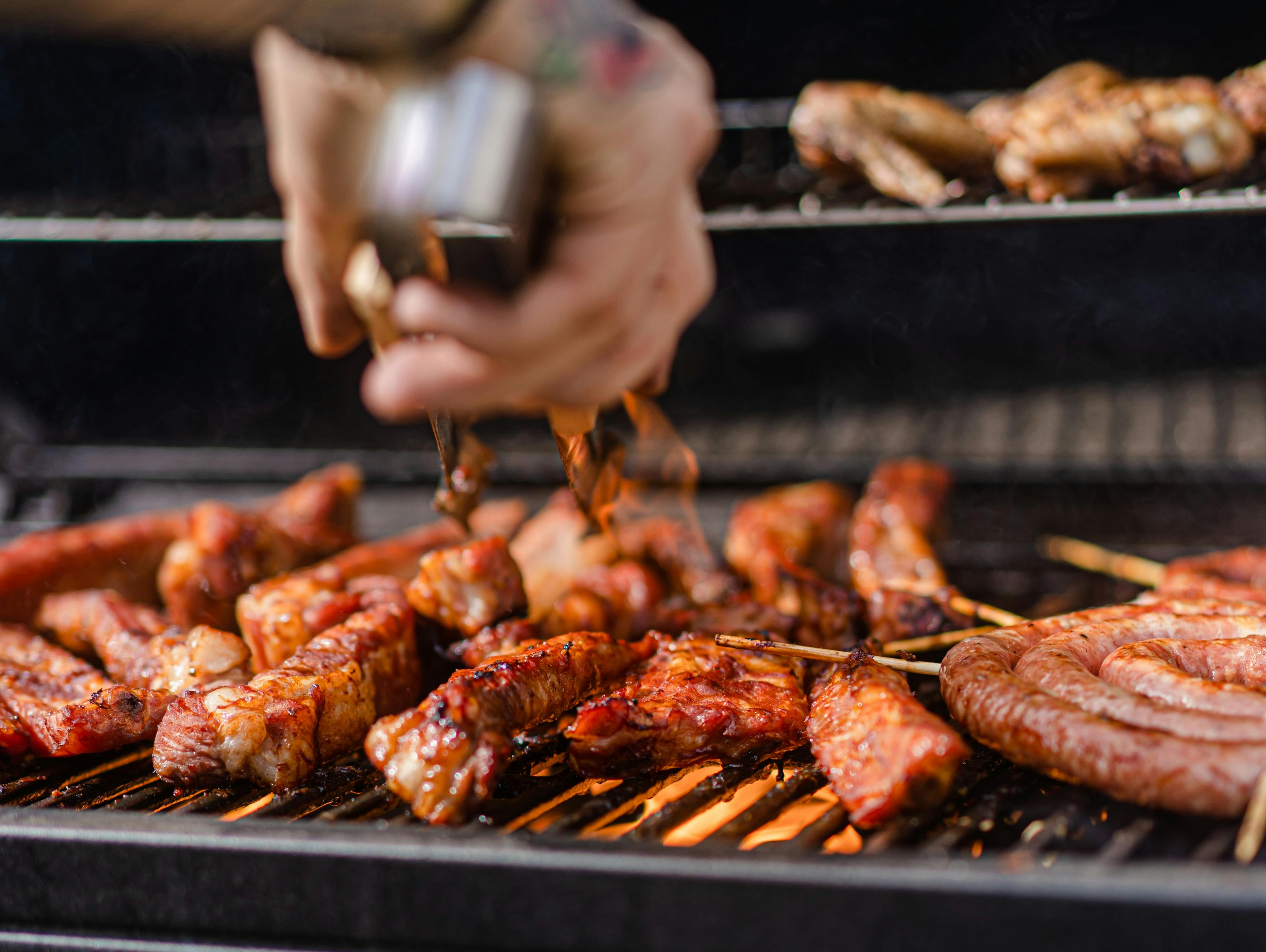 A chef cooking in a BBQ food truck. 