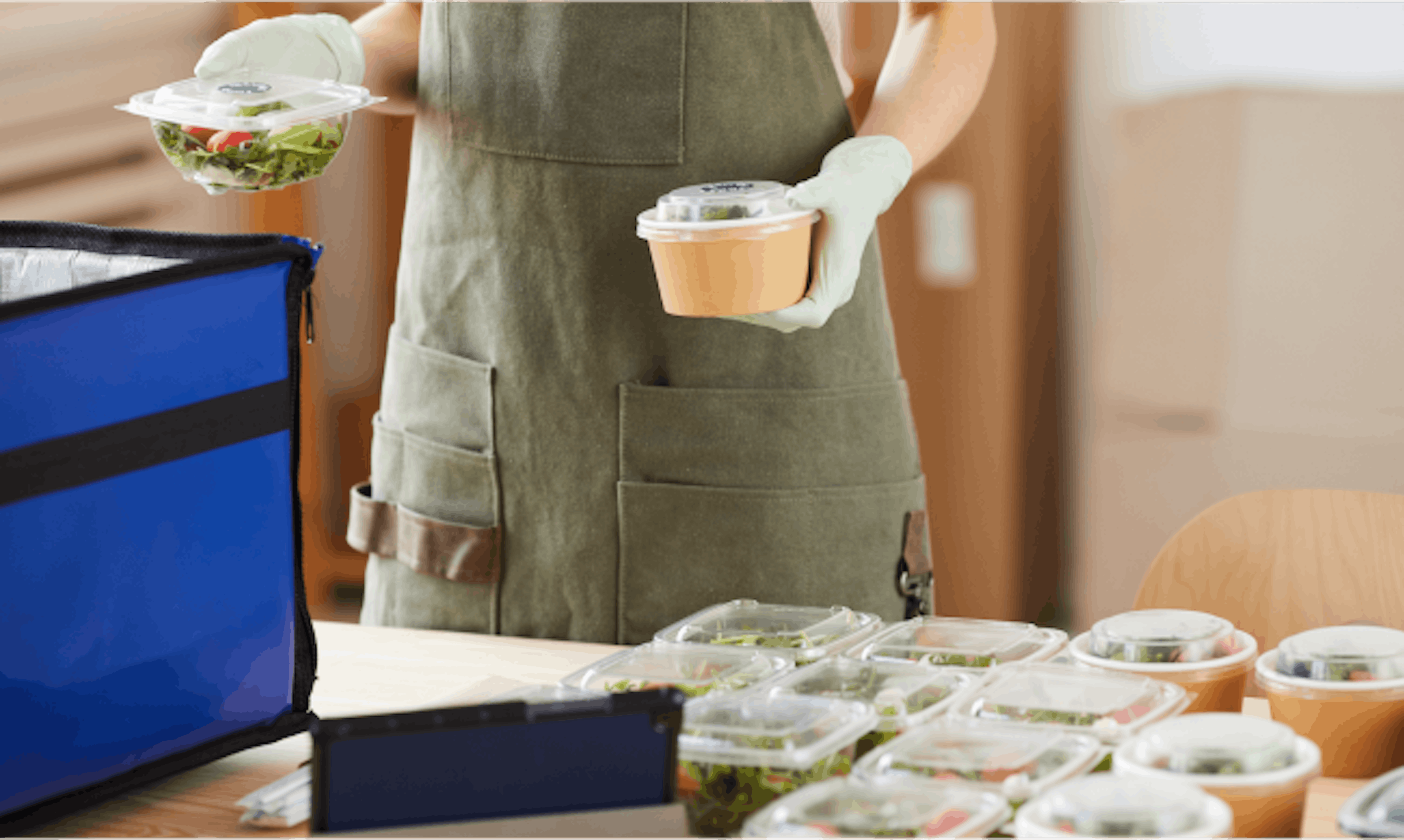 Image of a restaurant staff packing food for deliveyr