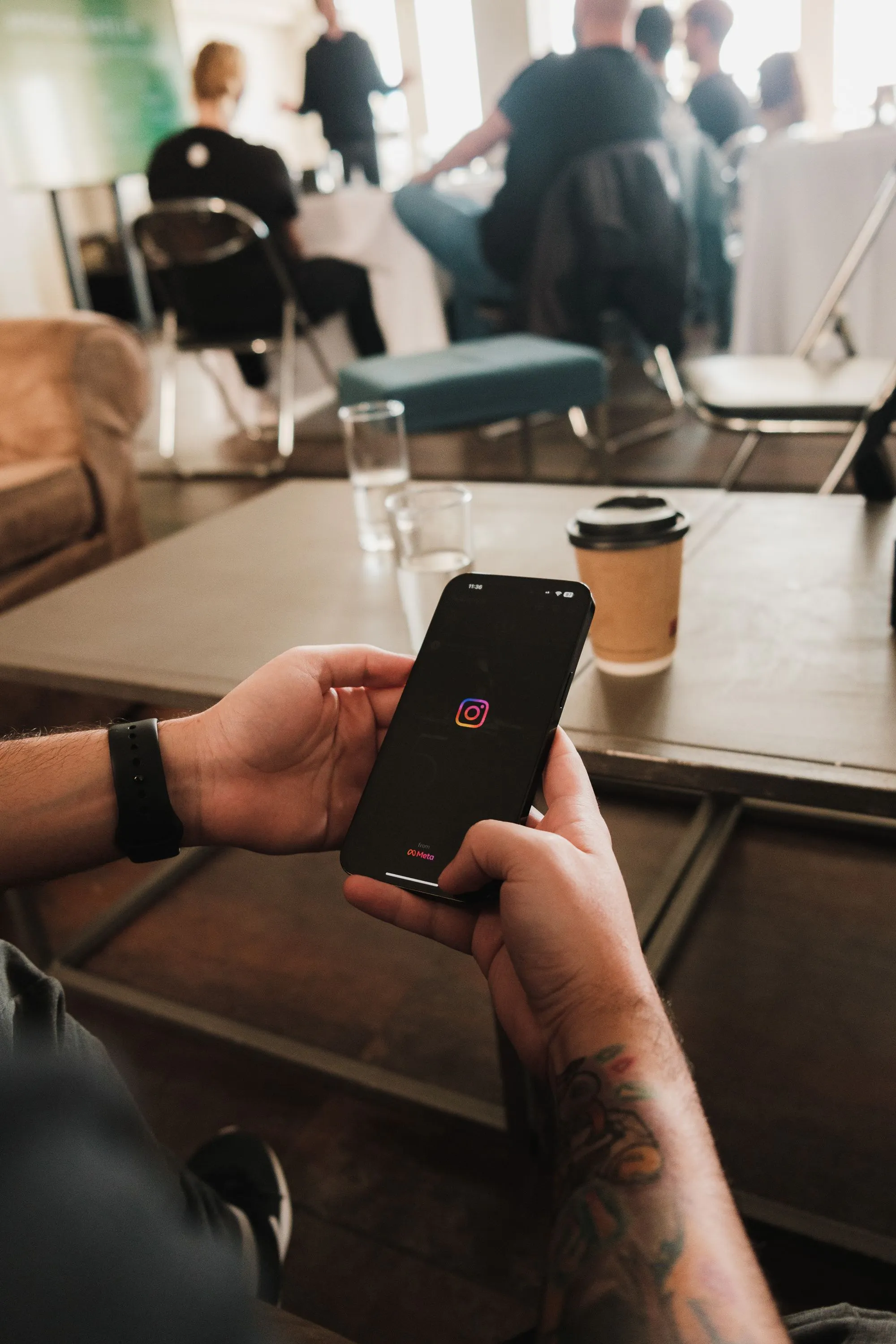 Image of restaurant worker scrolling on iPhone behind the counter