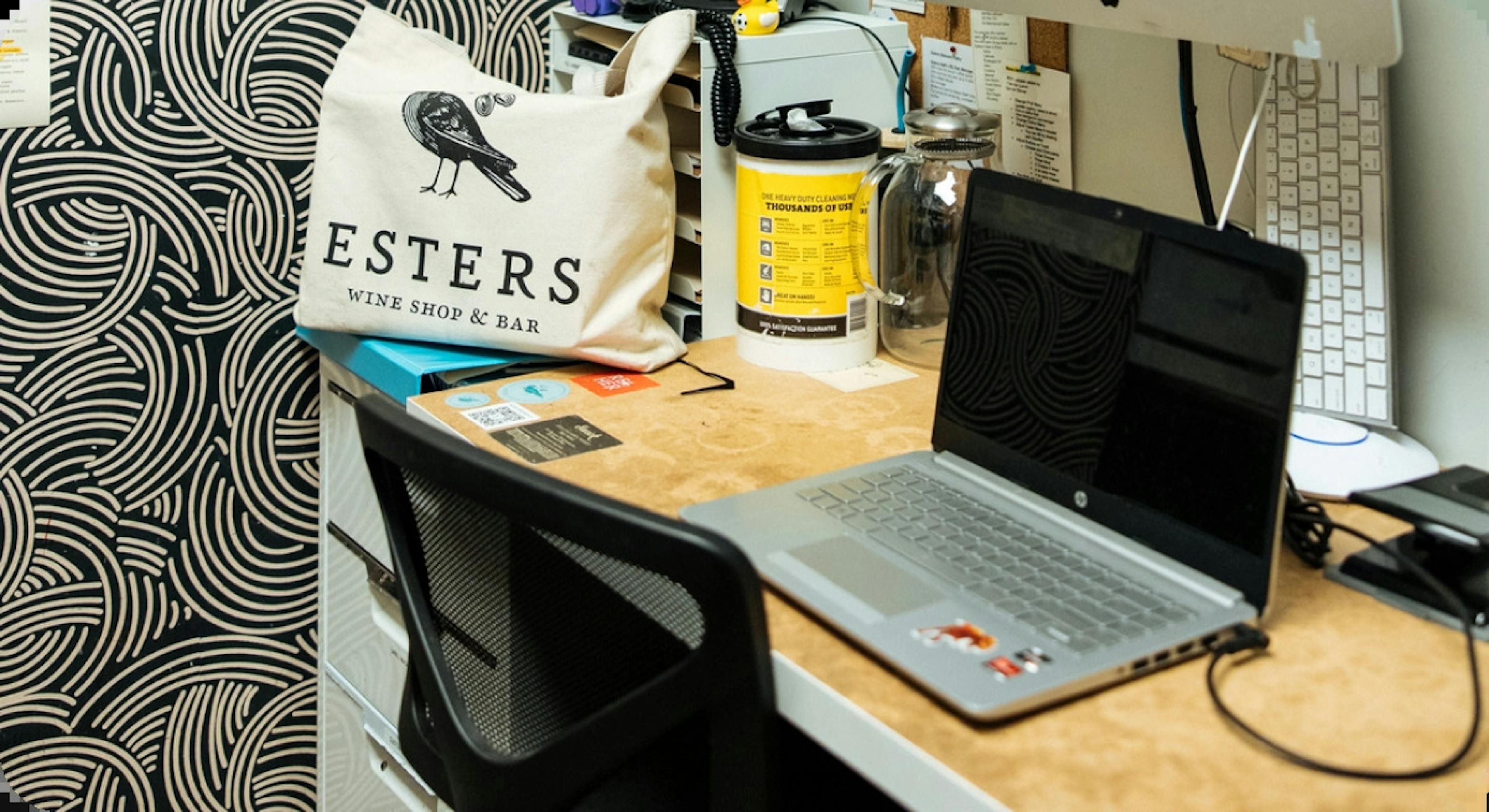 Image of a laptop on a desk in the back office of a restaurant