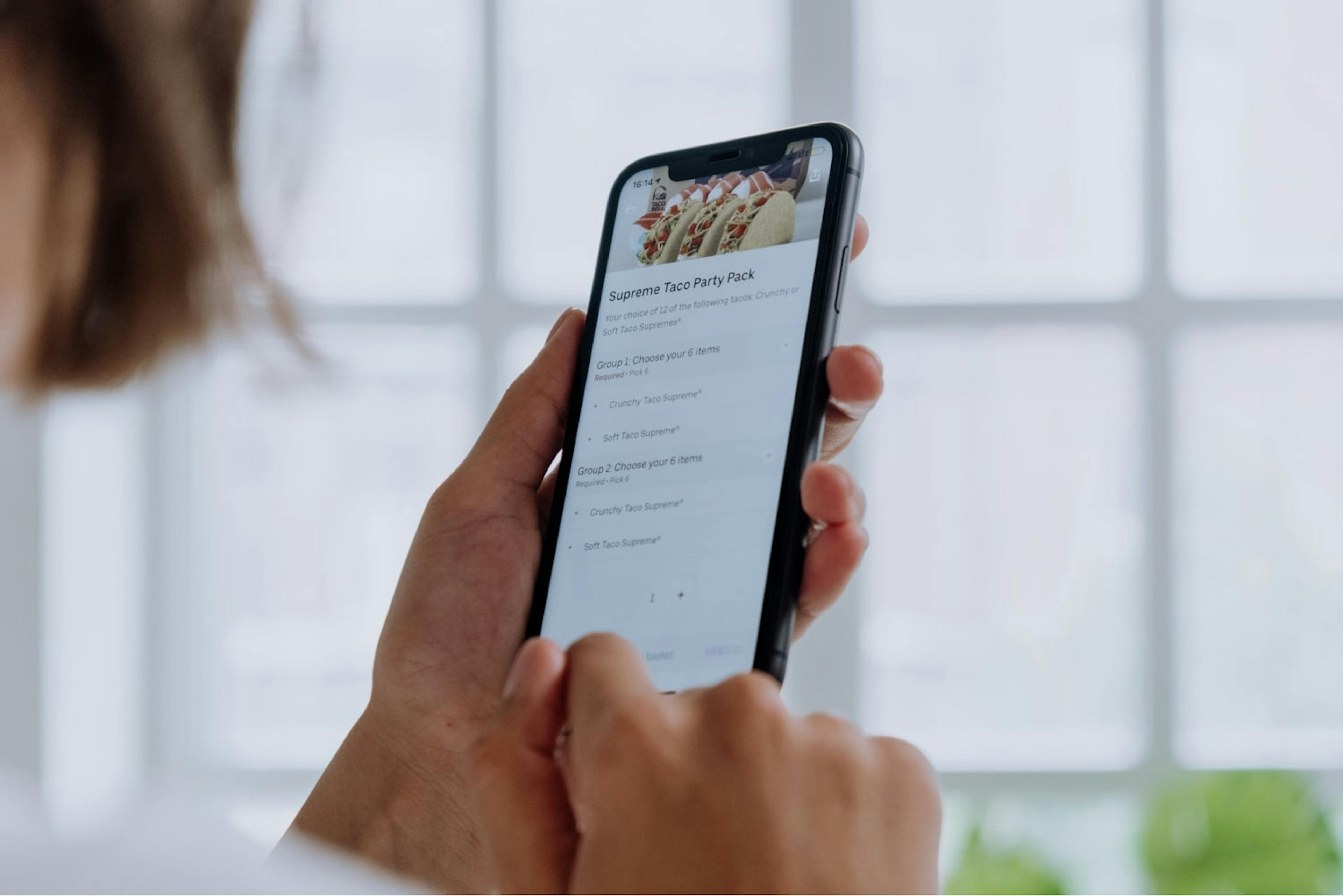 Image of a person ordering food through the Uber Eats app on their phone