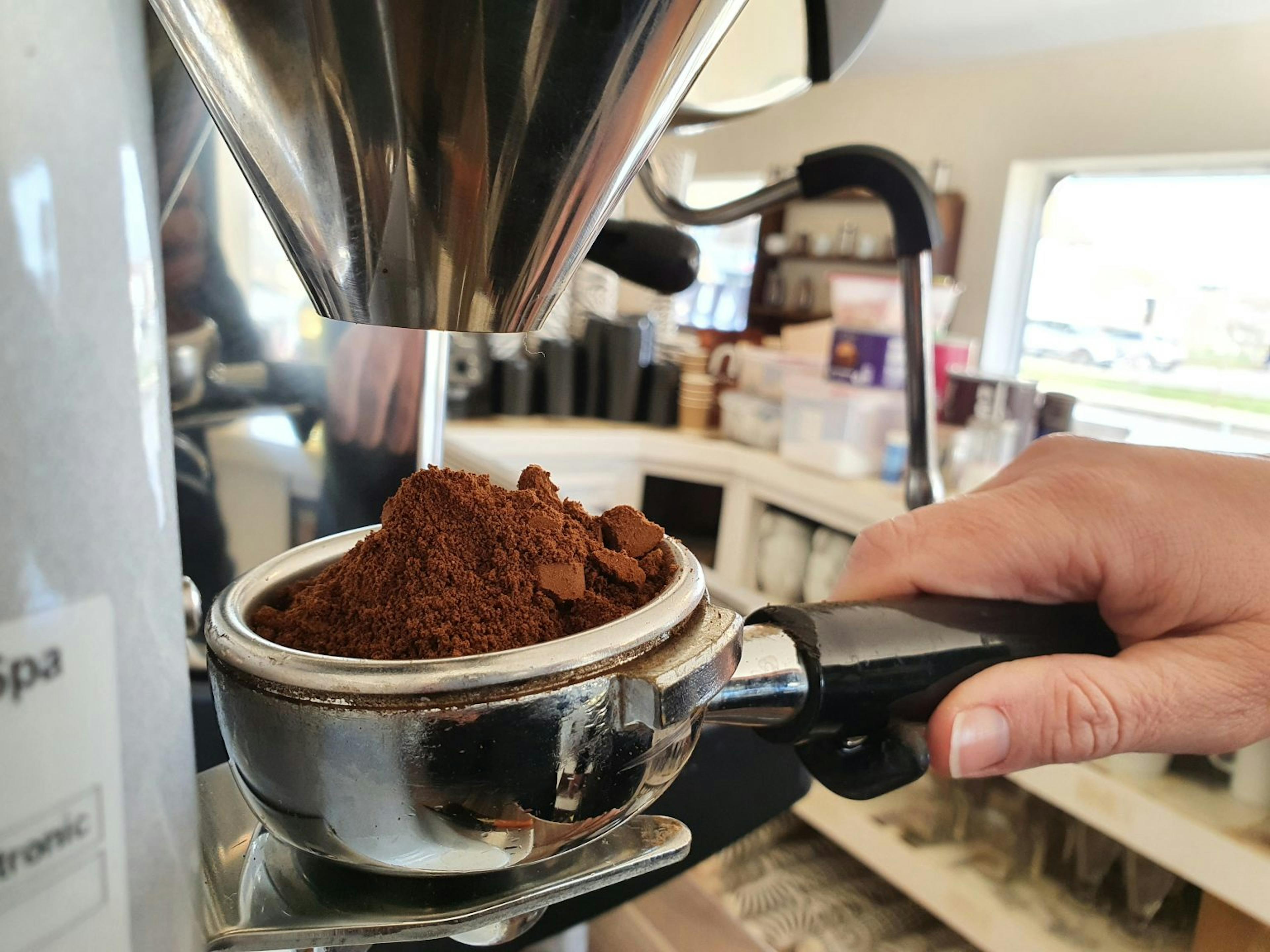 Image of a portafilter filled with ground coffee