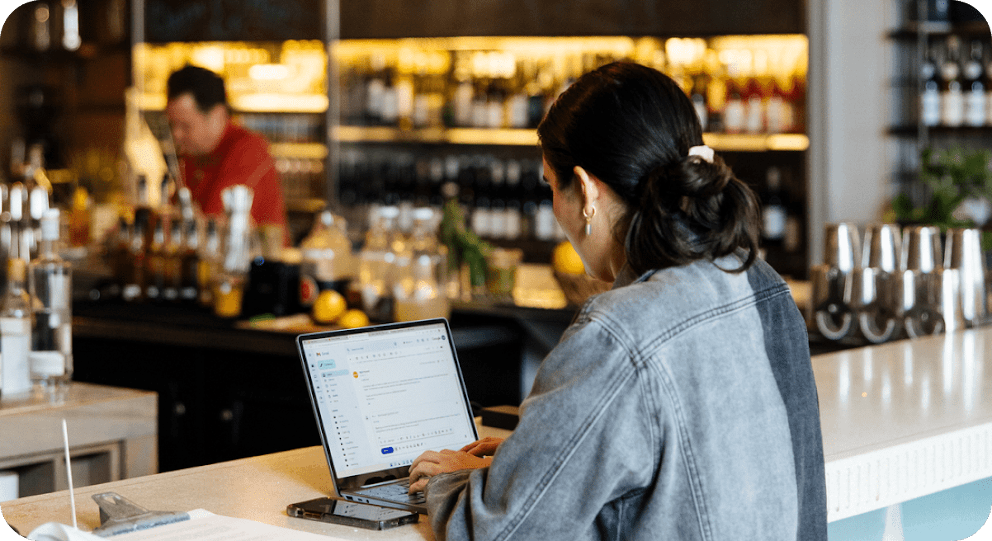 A woman using a computer at a restaurant. 