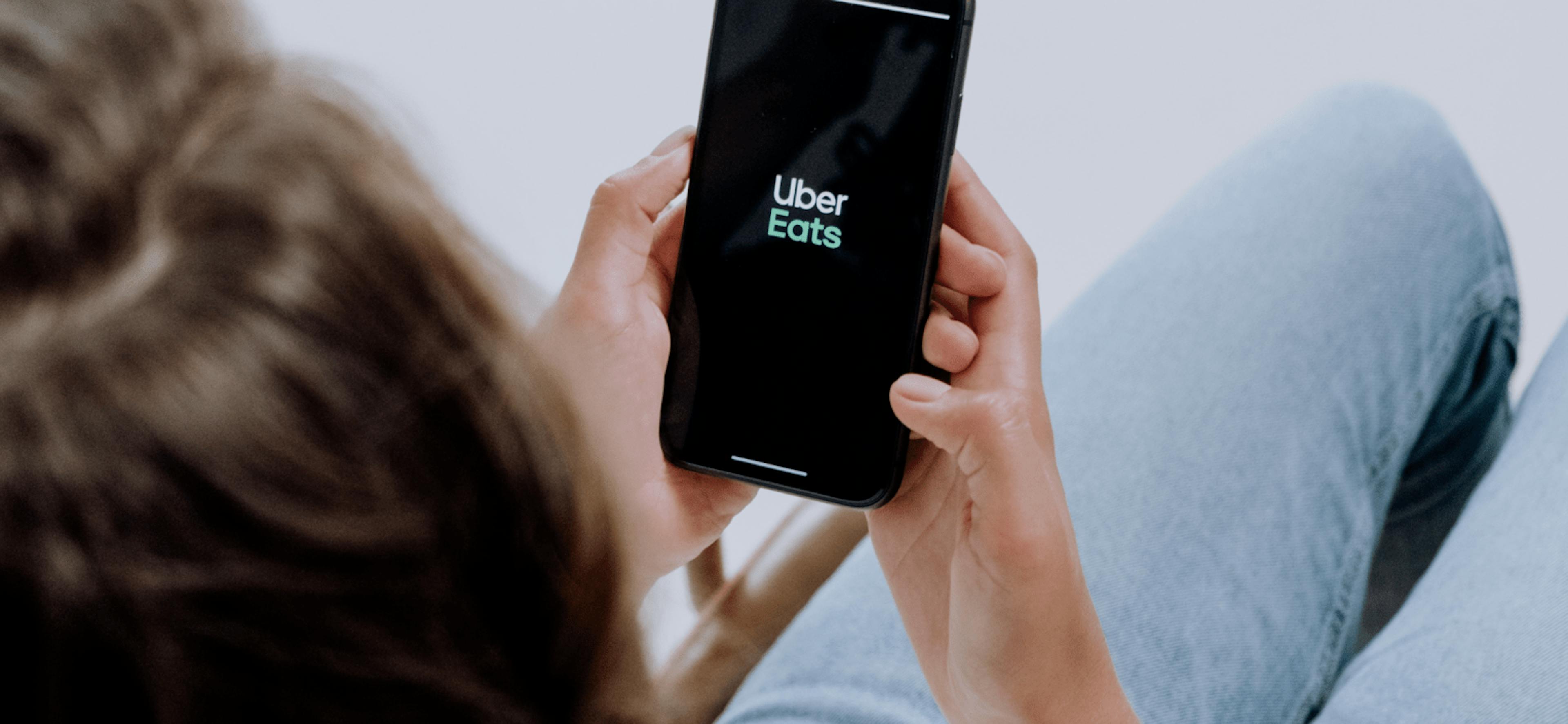 Image of a person using the Uber Eats app on their phone
