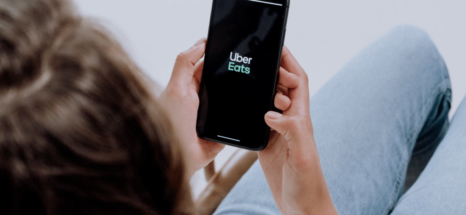 Image of a person using the Uber Eats app on their phone