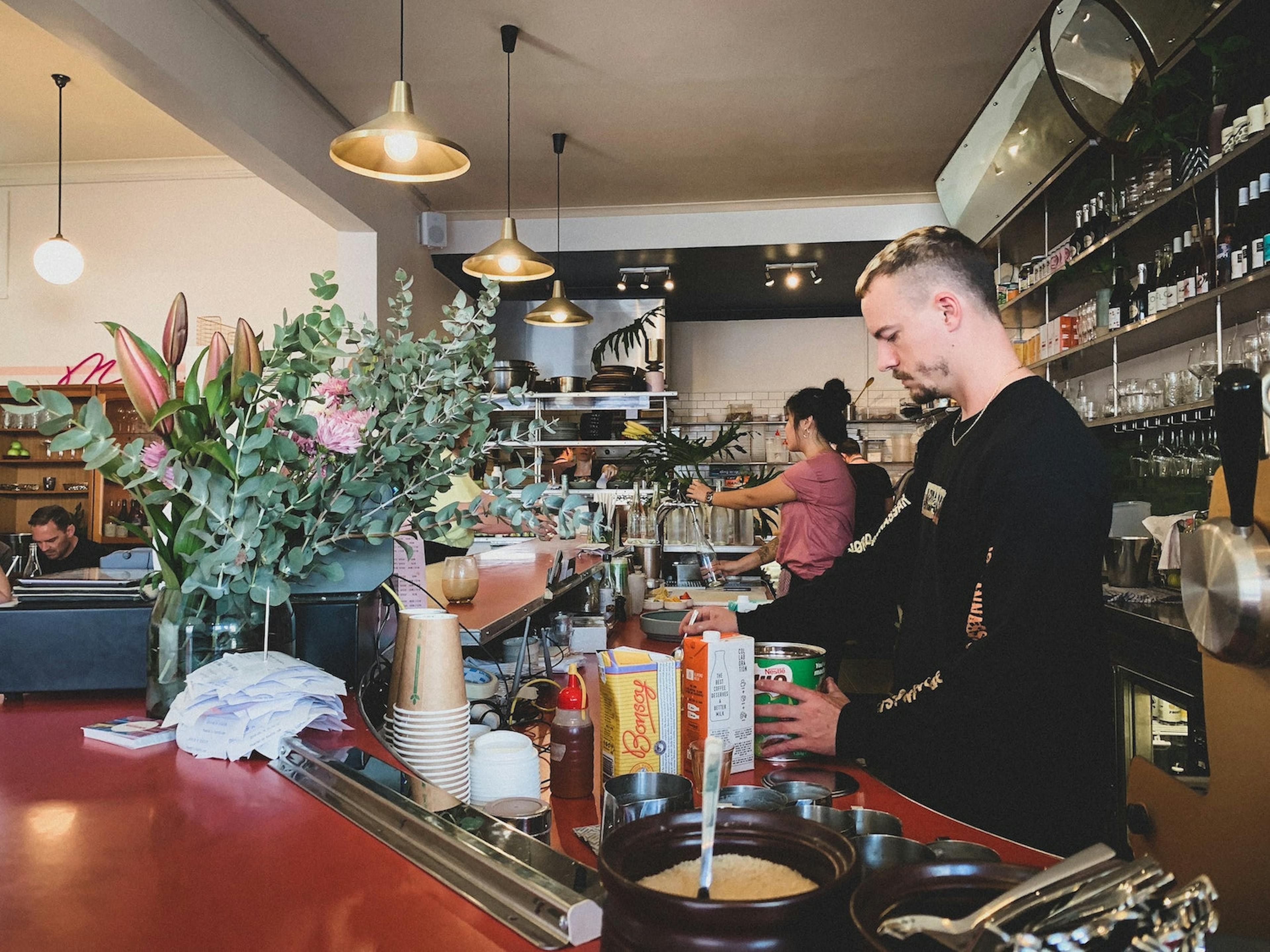 Image of a barista making a Milo drink behind the counter