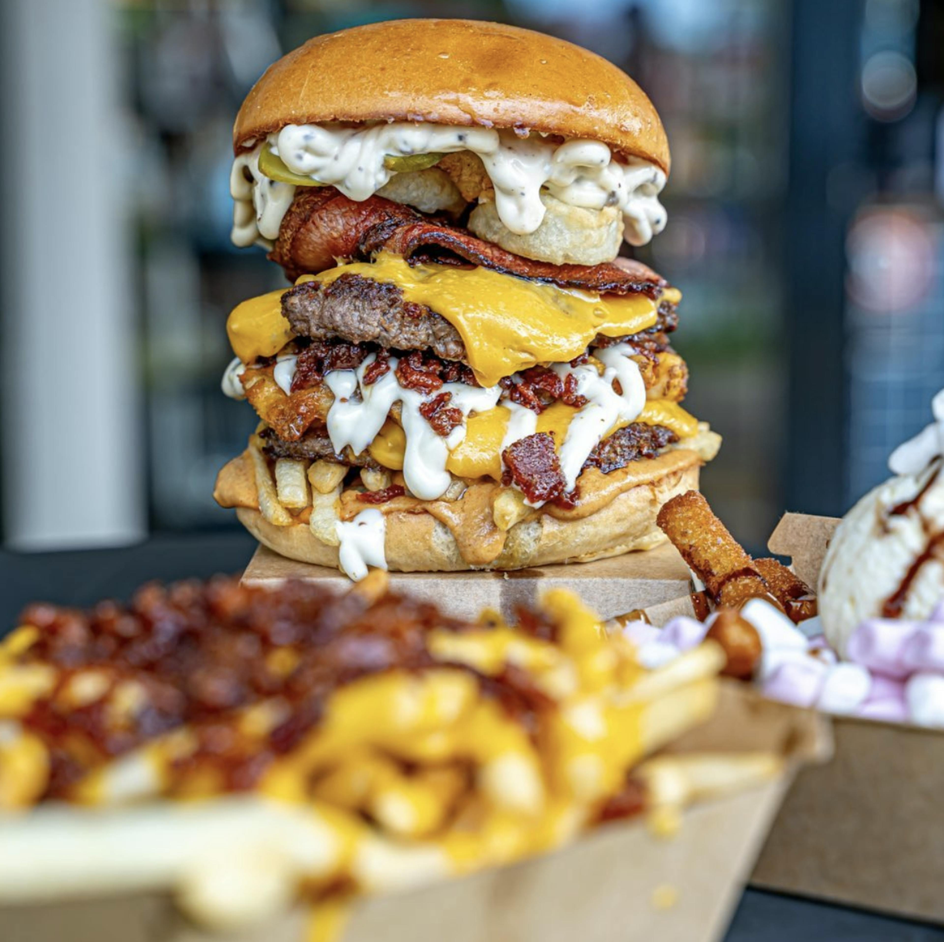 Image of a triple patty burger with melting cheese 