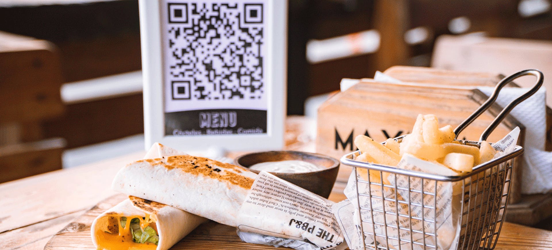 Image of a QR code stand behind food on the table 