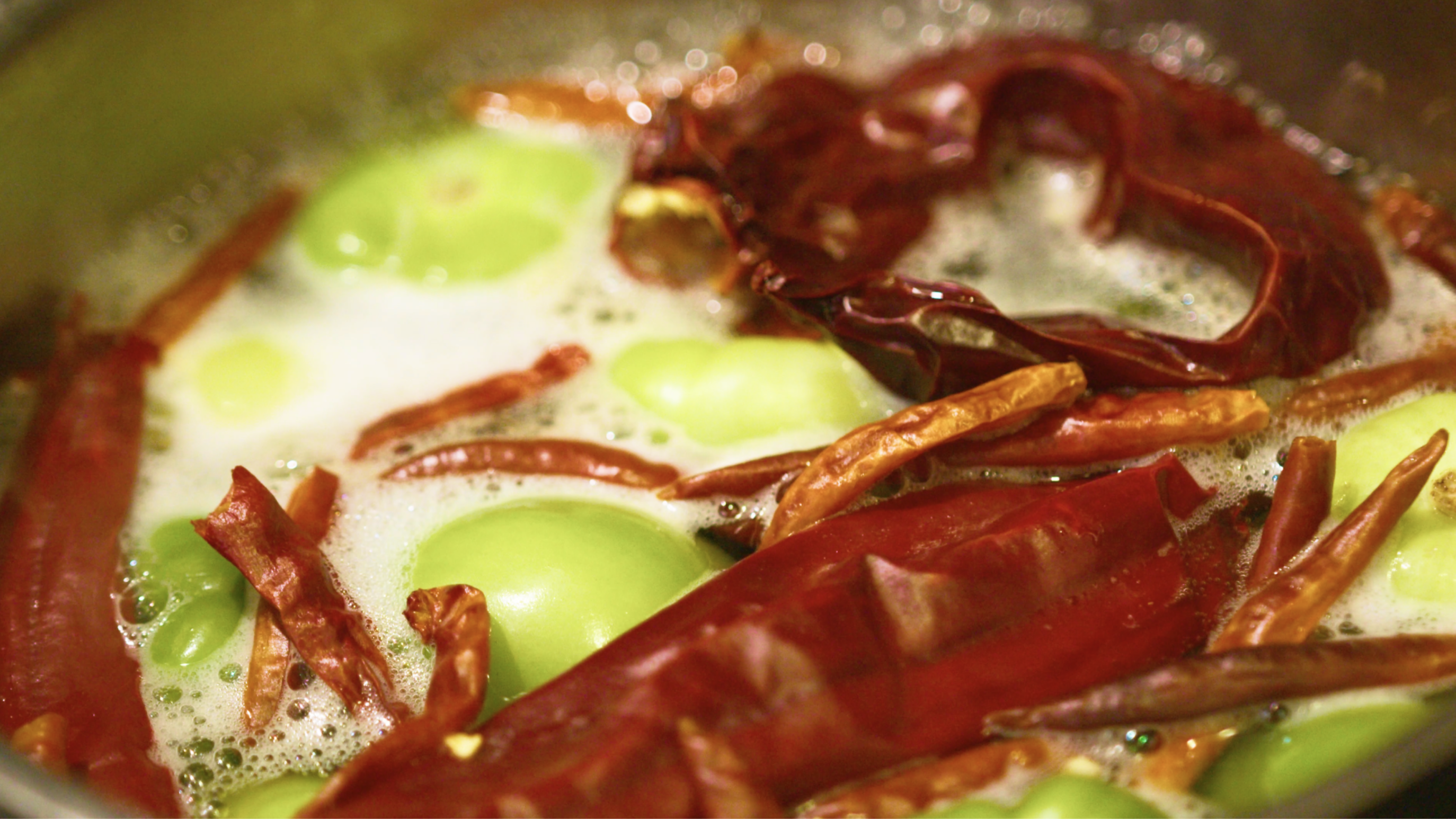 Close up of a hot meal topped with red peppers