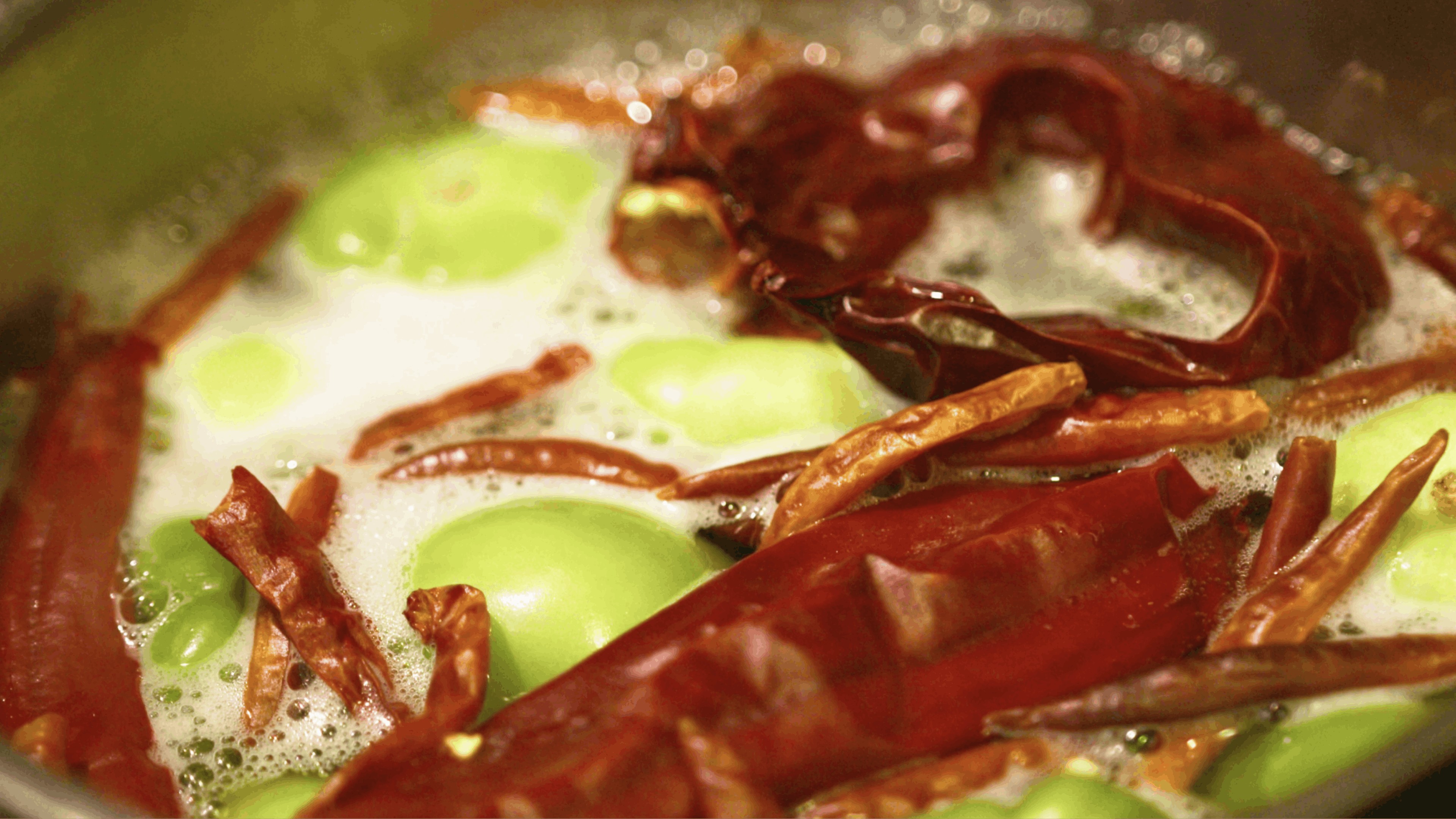 Close up of a hot meal topped with red peppers