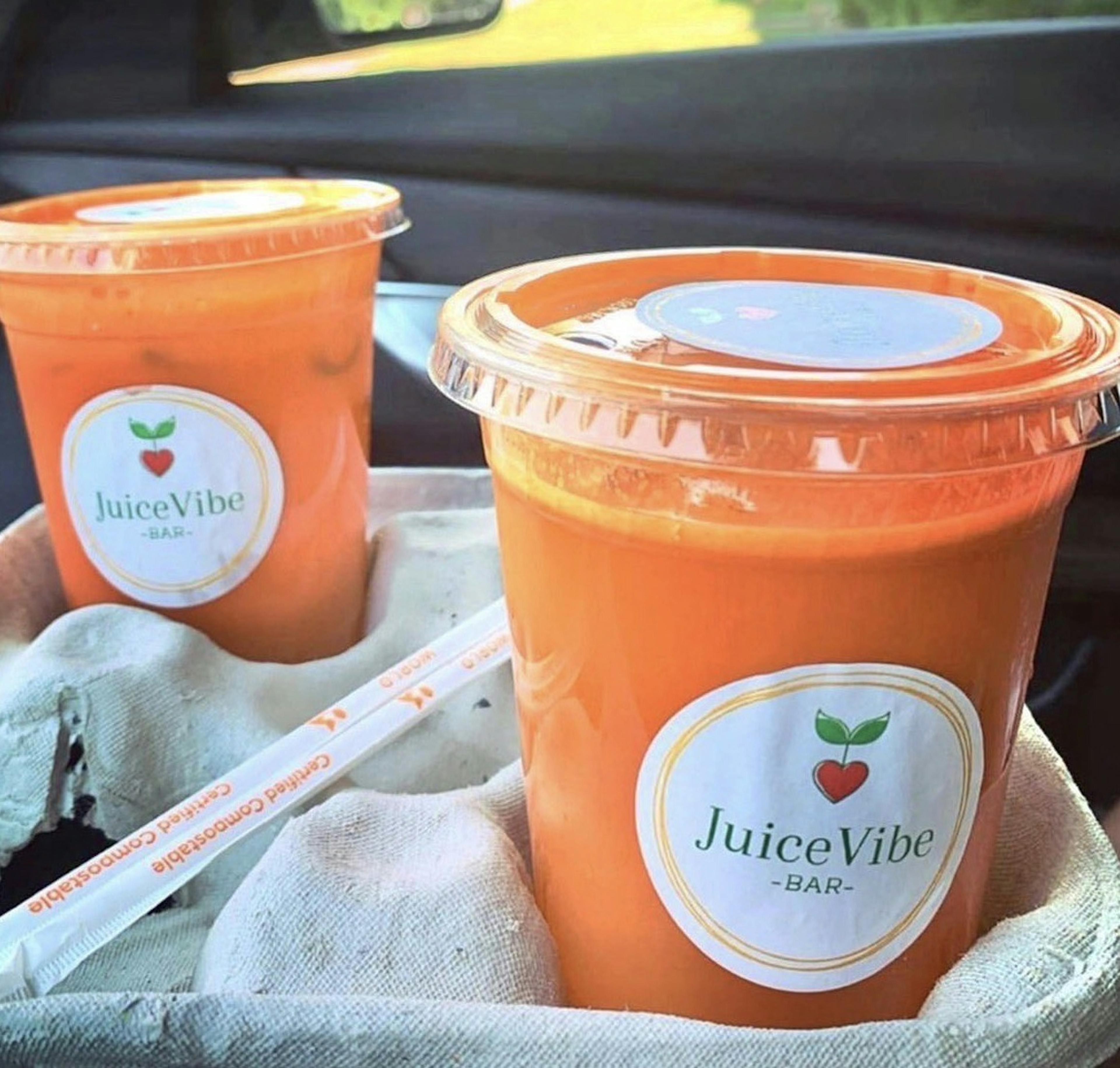 Image of two cups of cold pressed carrot juice from Juice Vibe Bar