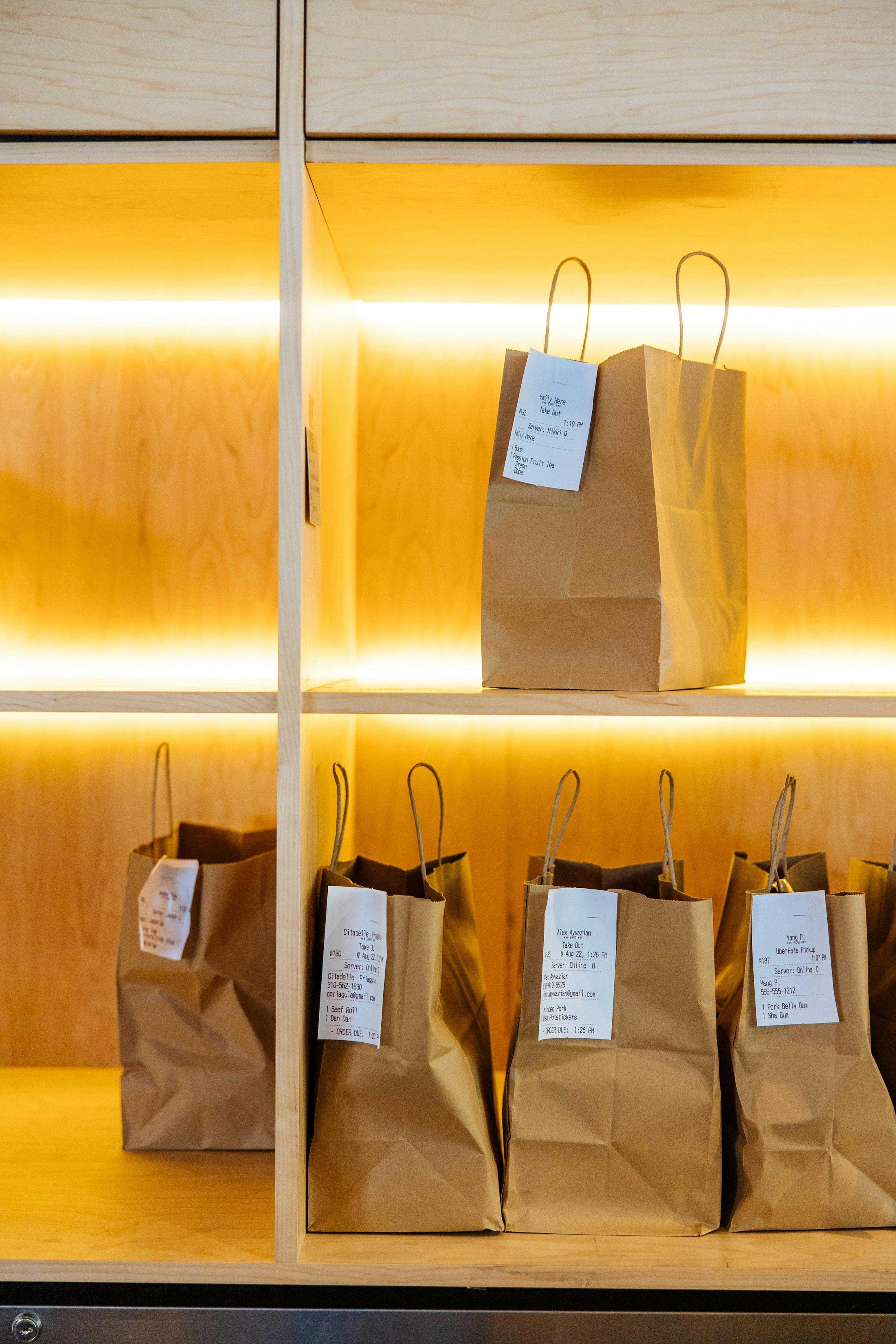 Image of delivery bags on a shelf waiting to be picked up from a restaurant