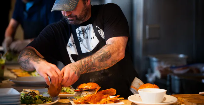 Image of a restaurant employee preparing food