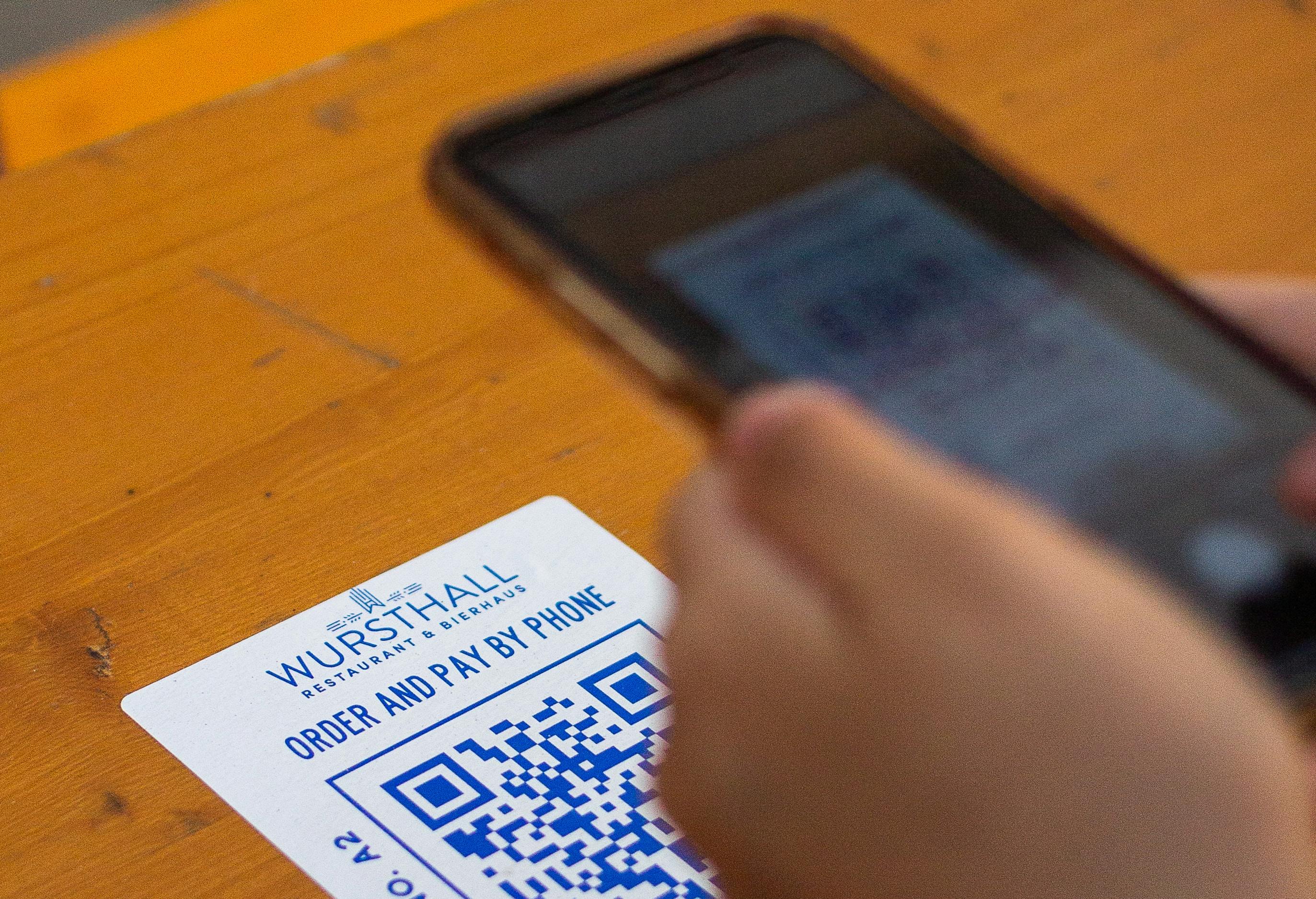 Cell phone scanning a restaurant's QR code menu.