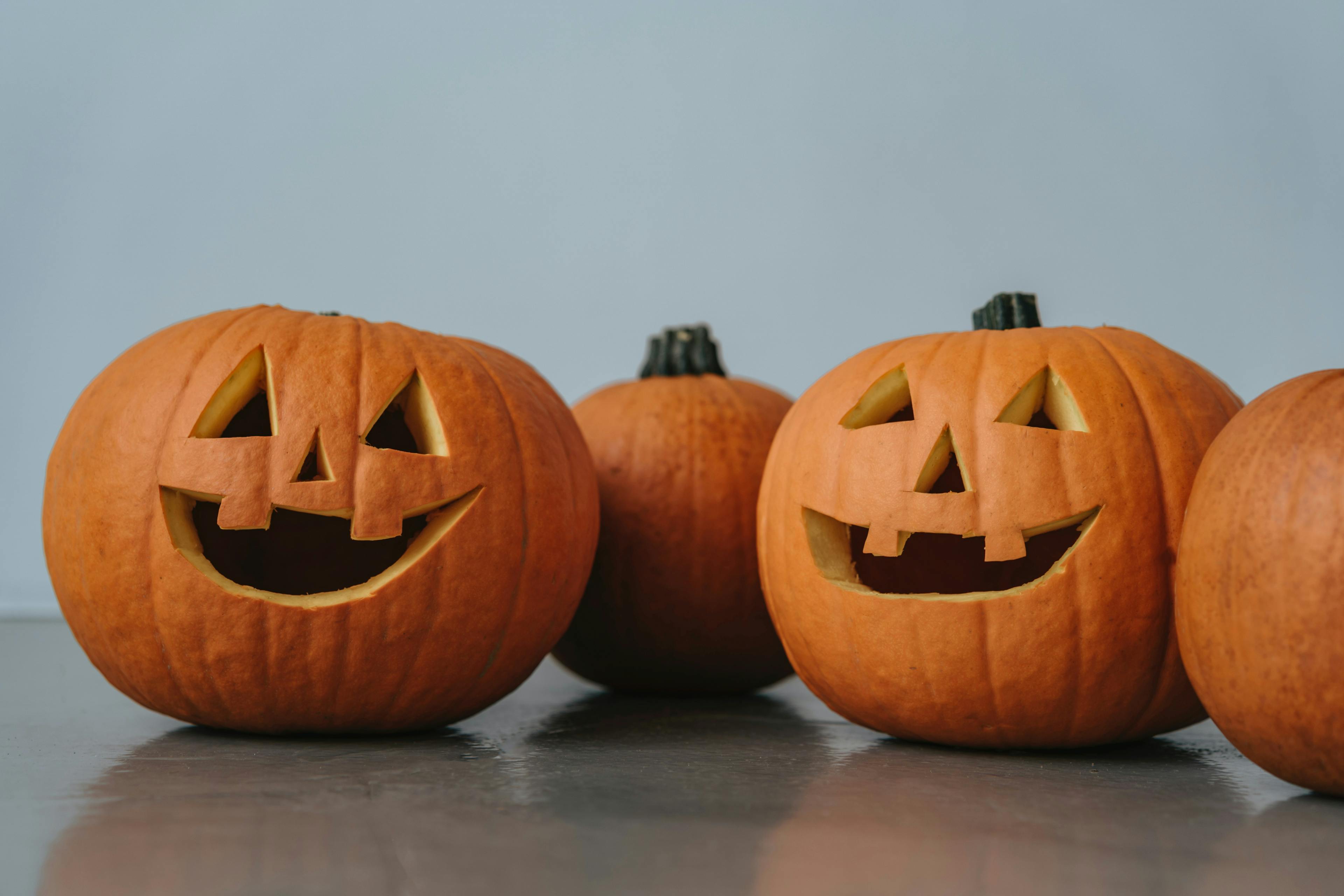 Image of three Jack-O-Lanterns on a greyish blue background