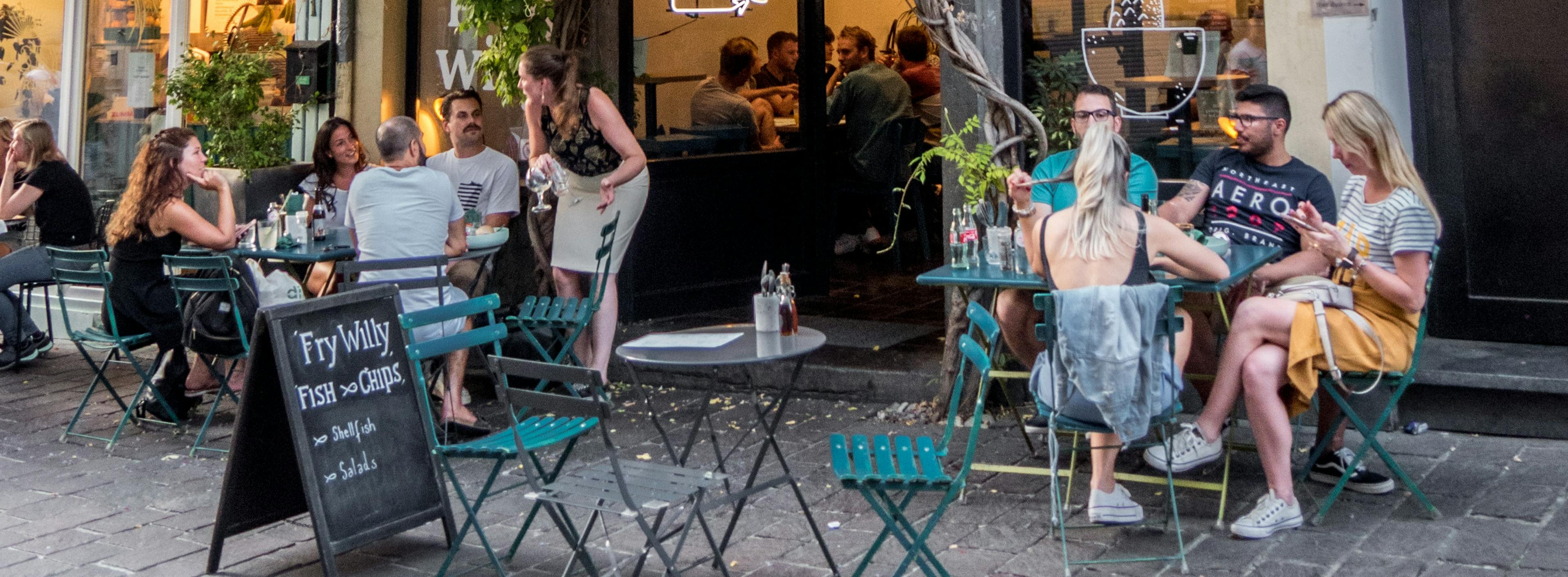 Restaurant customers eating outside. 