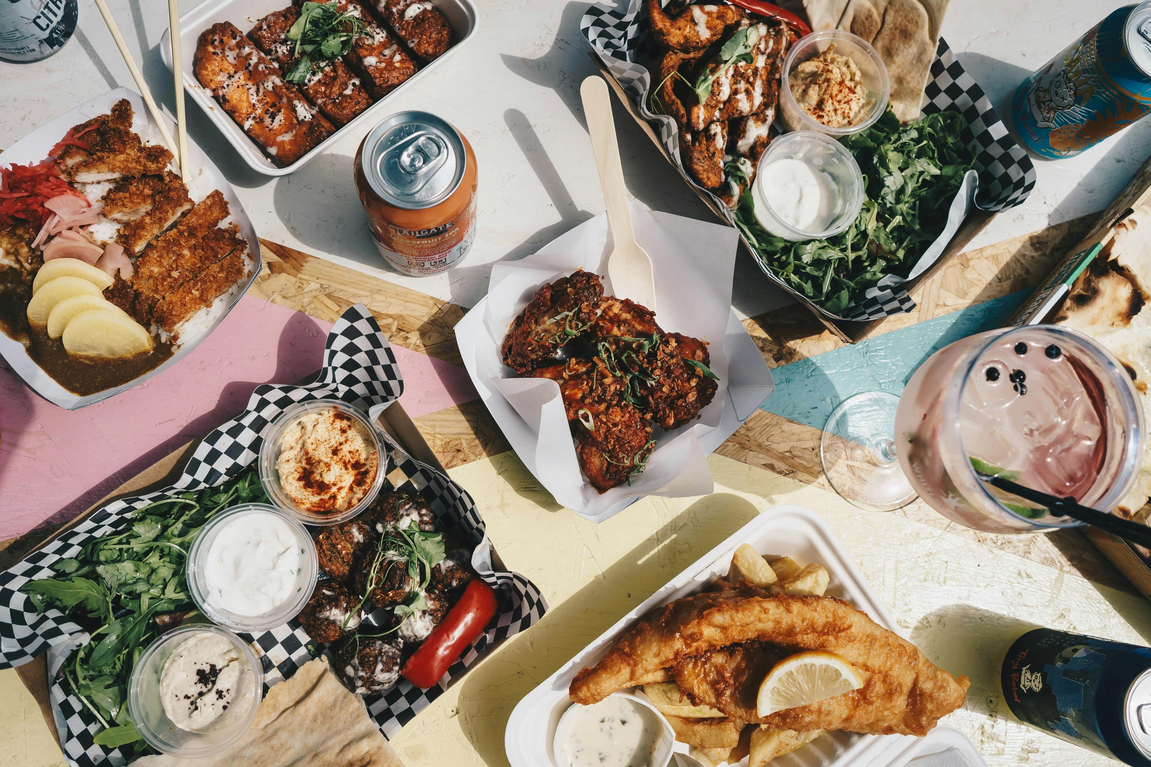 Image of assorted food delivery items including fried fish, chicken, drinks and more.