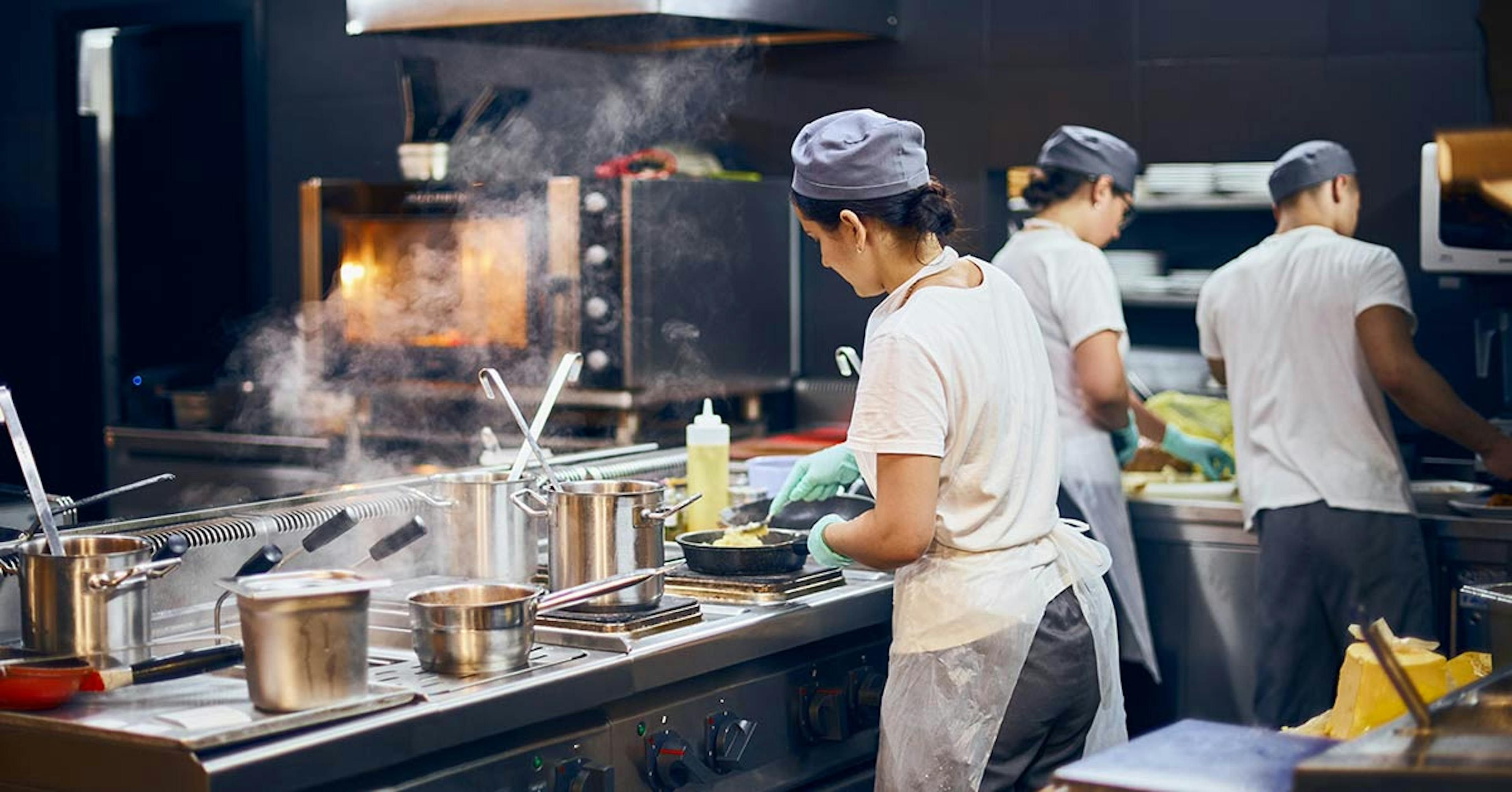 Image of restaurant cooks preparing meals for delivery from a ghost kitchen.