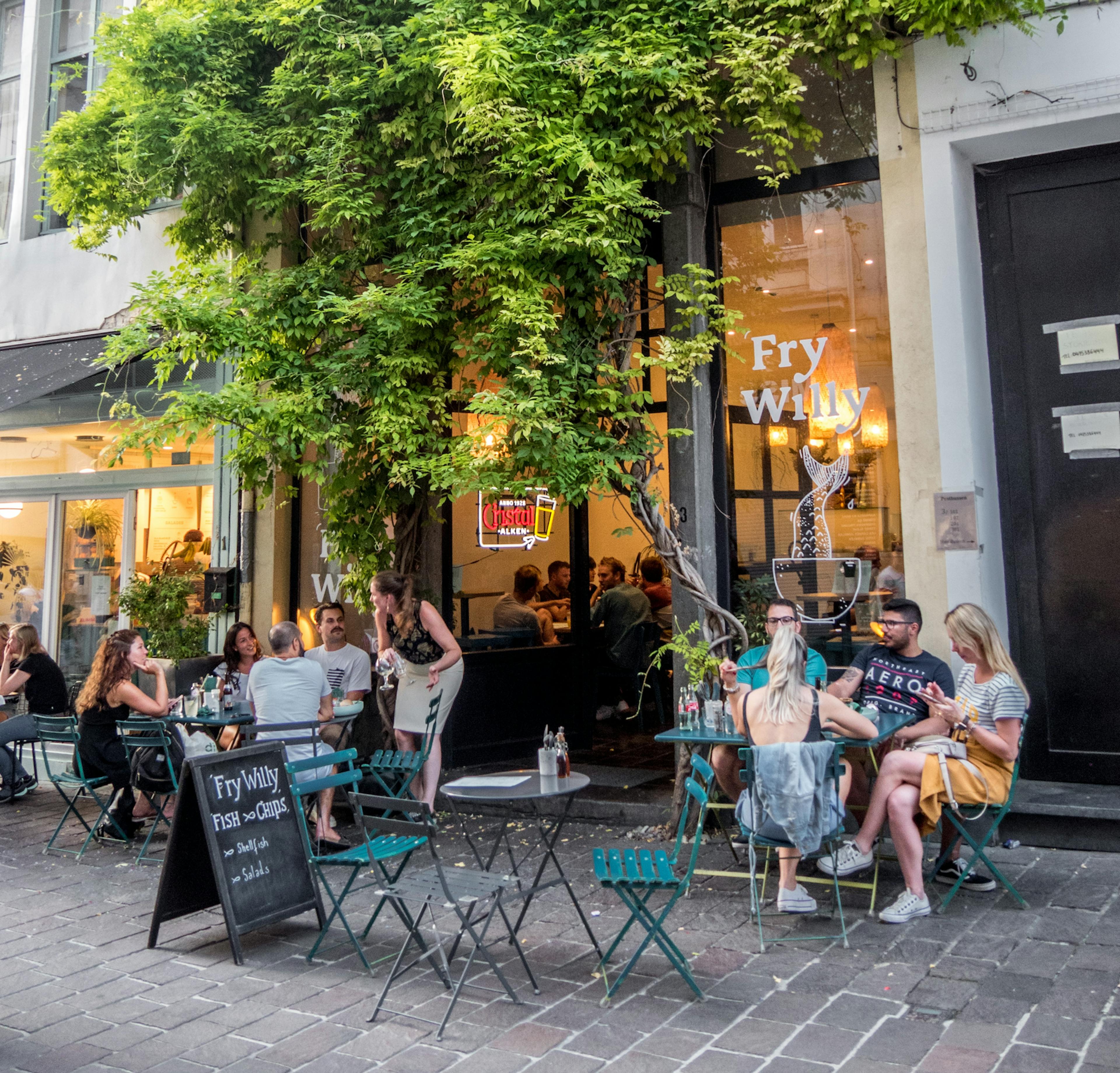 Restaurant customers eating outside. 