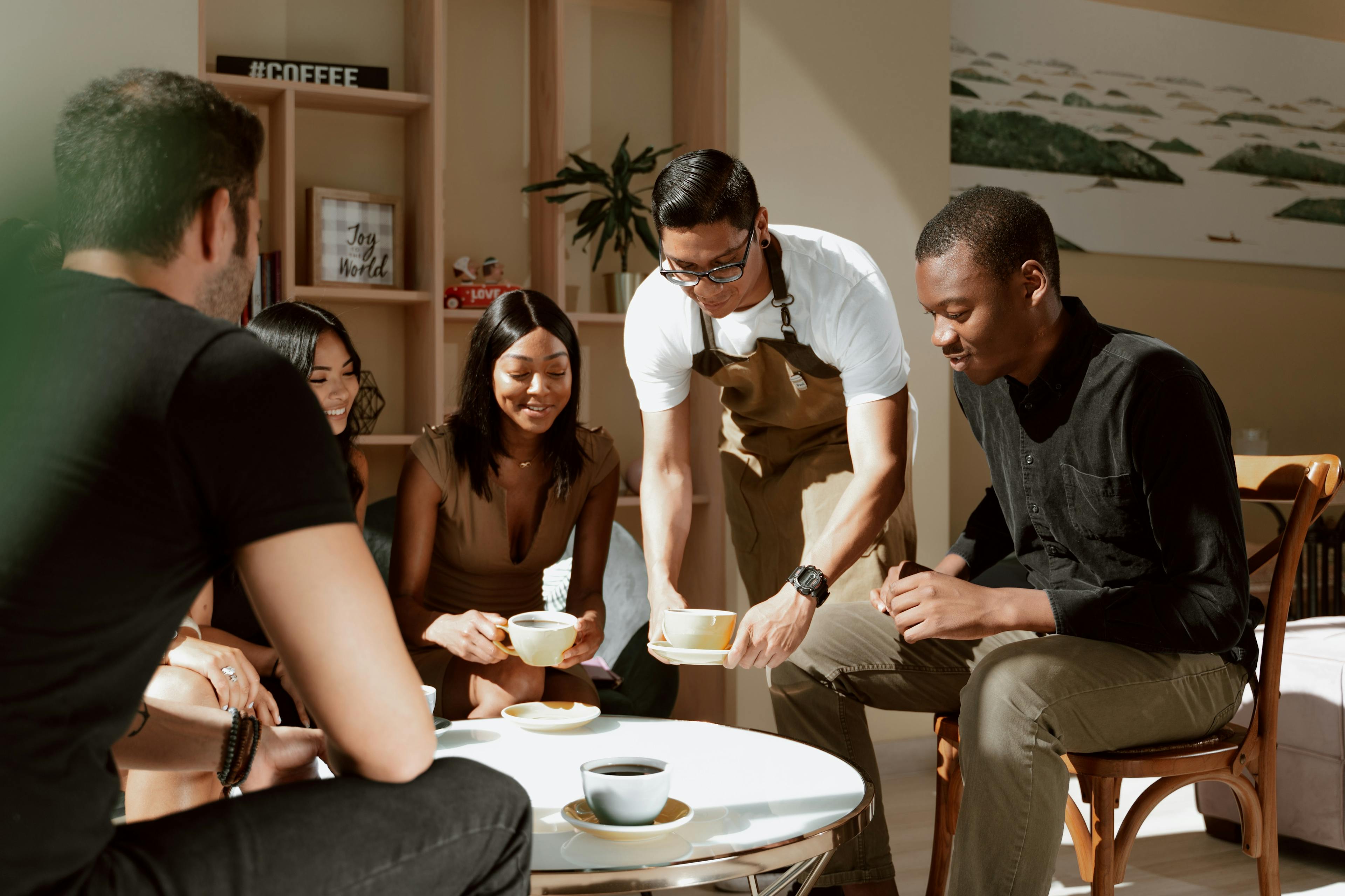 Restaurant customers being served by a waiter. 