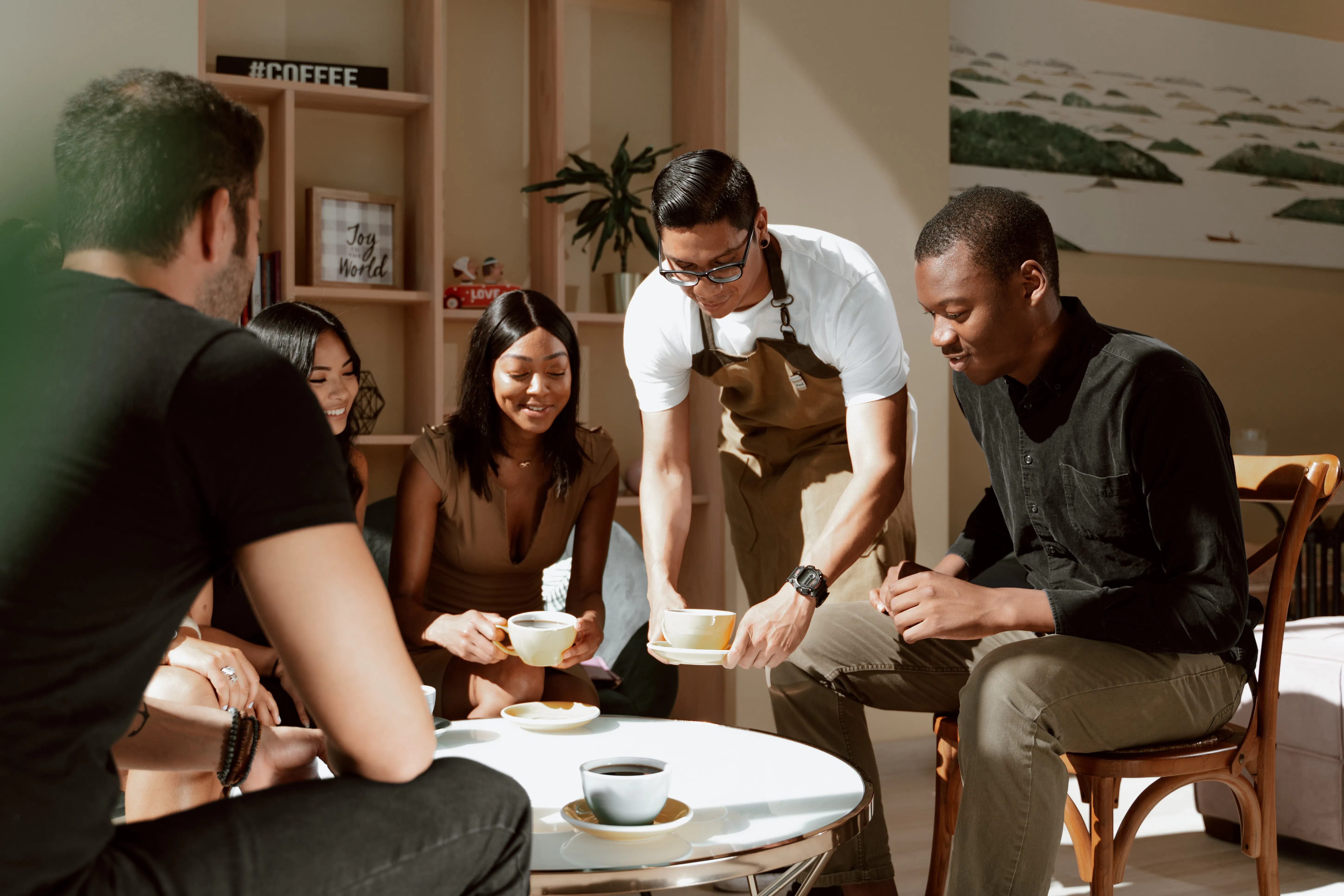 Restaurant customers being served by a waiter.