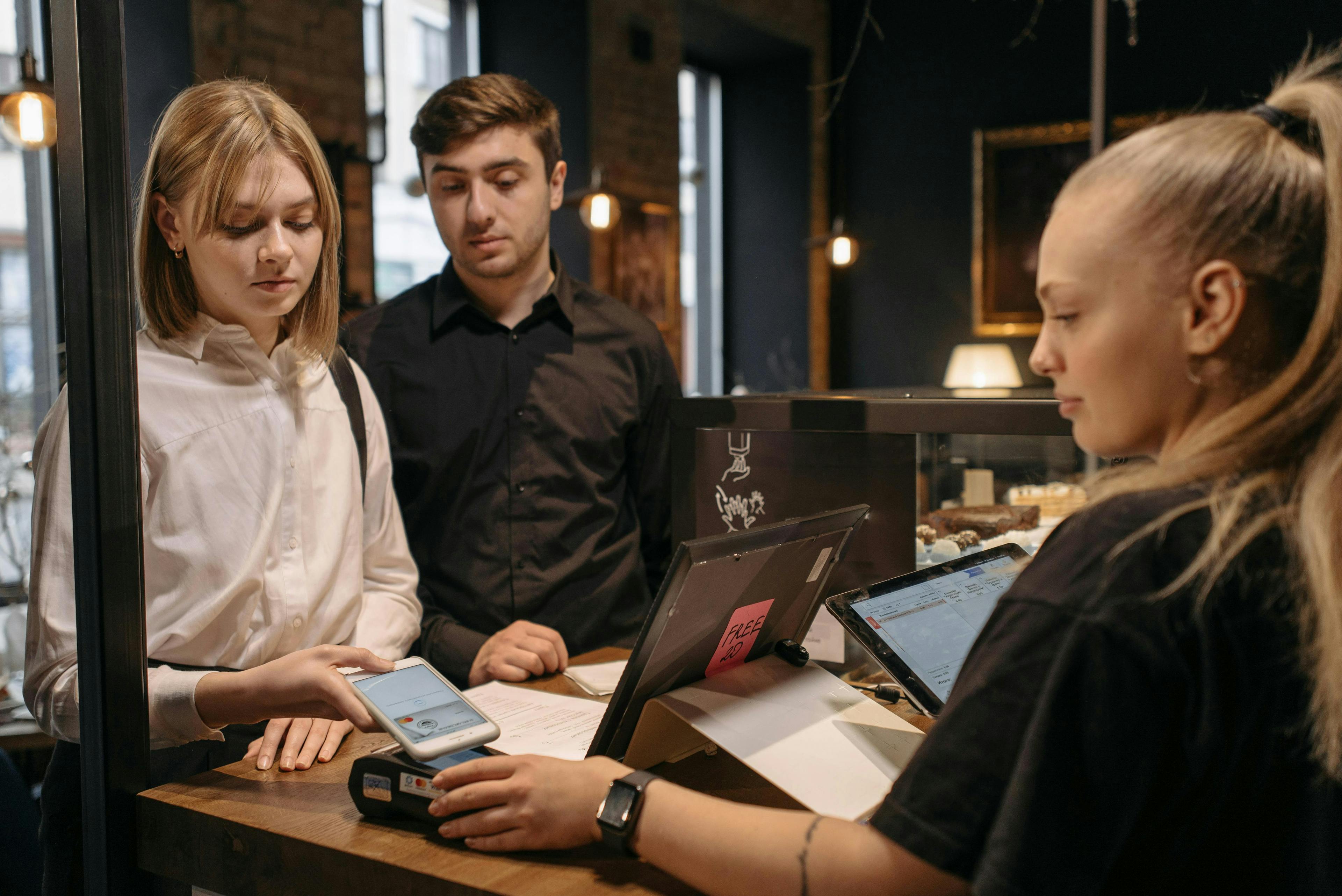 Customers paying for an order with a restaurant POS system. 