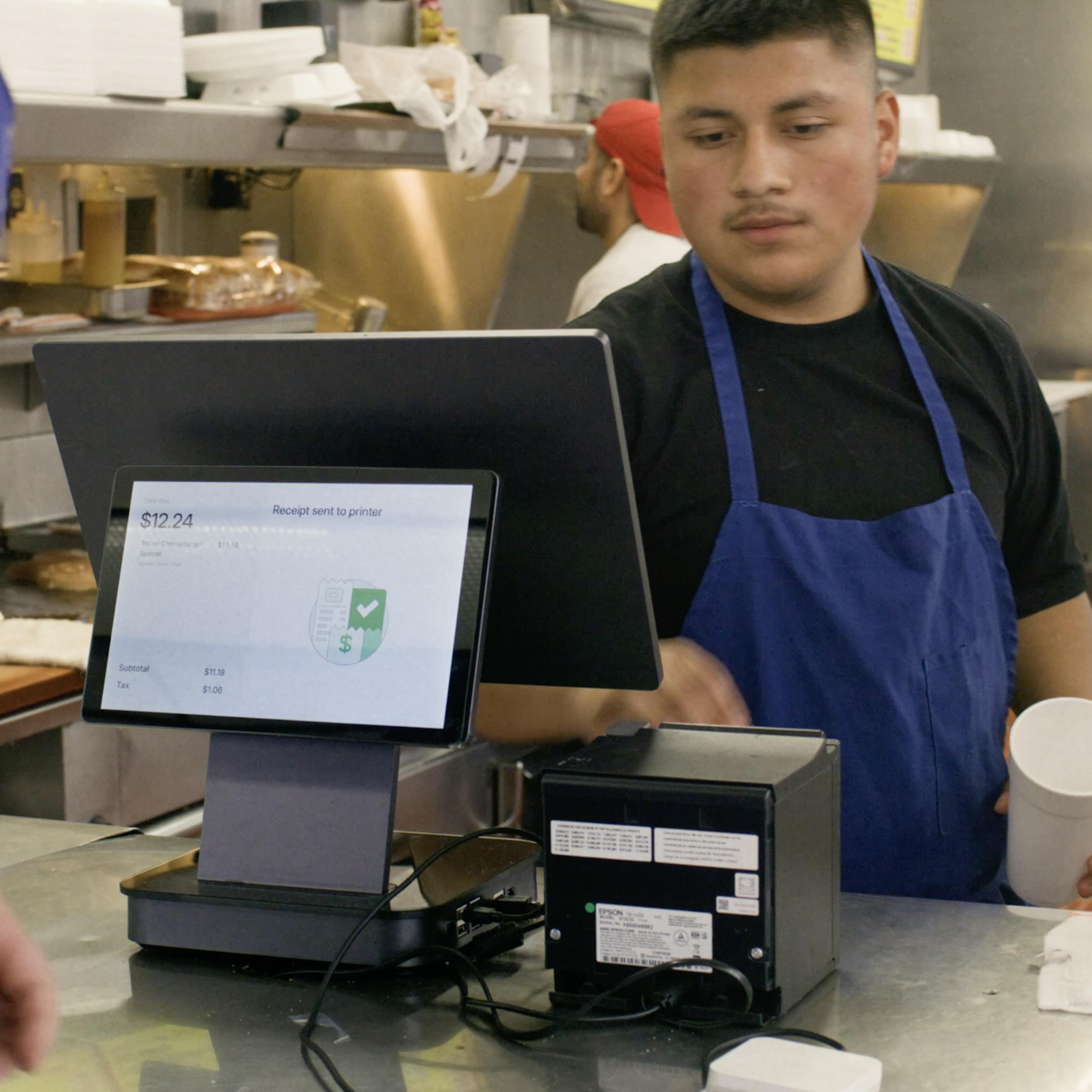 A restaurant staff member using Otter POS. 