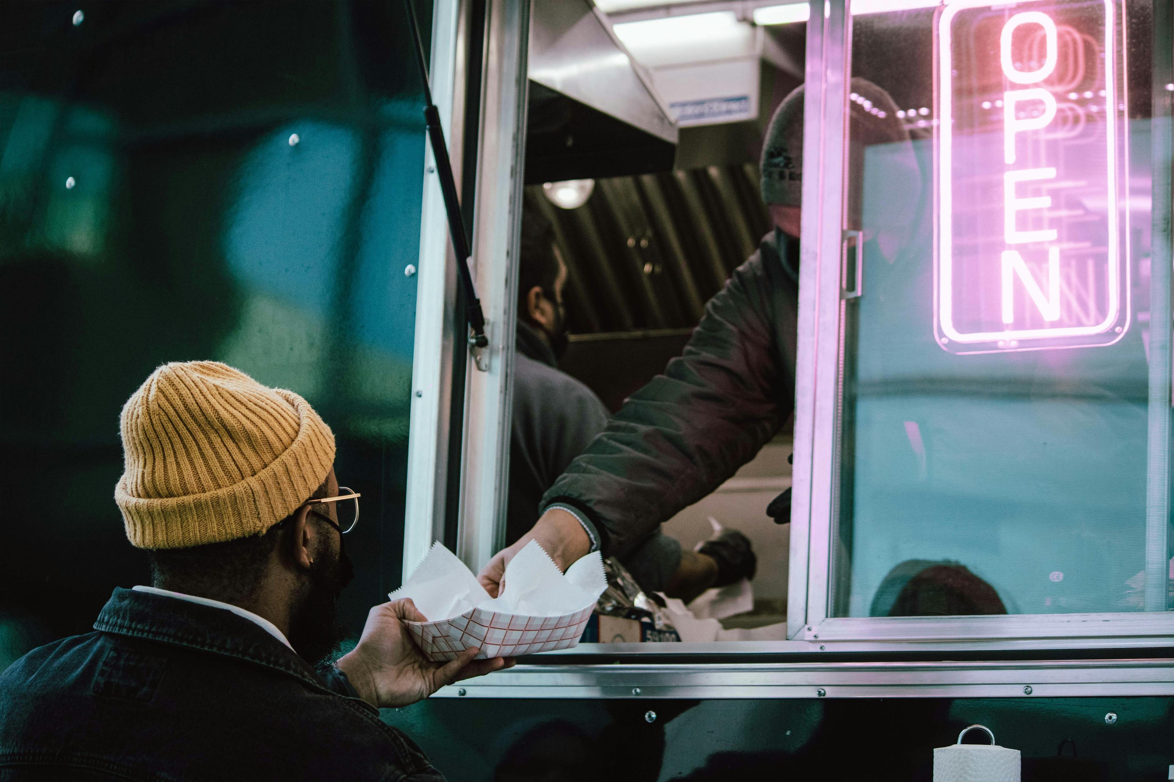 Man being served from a food truck. 