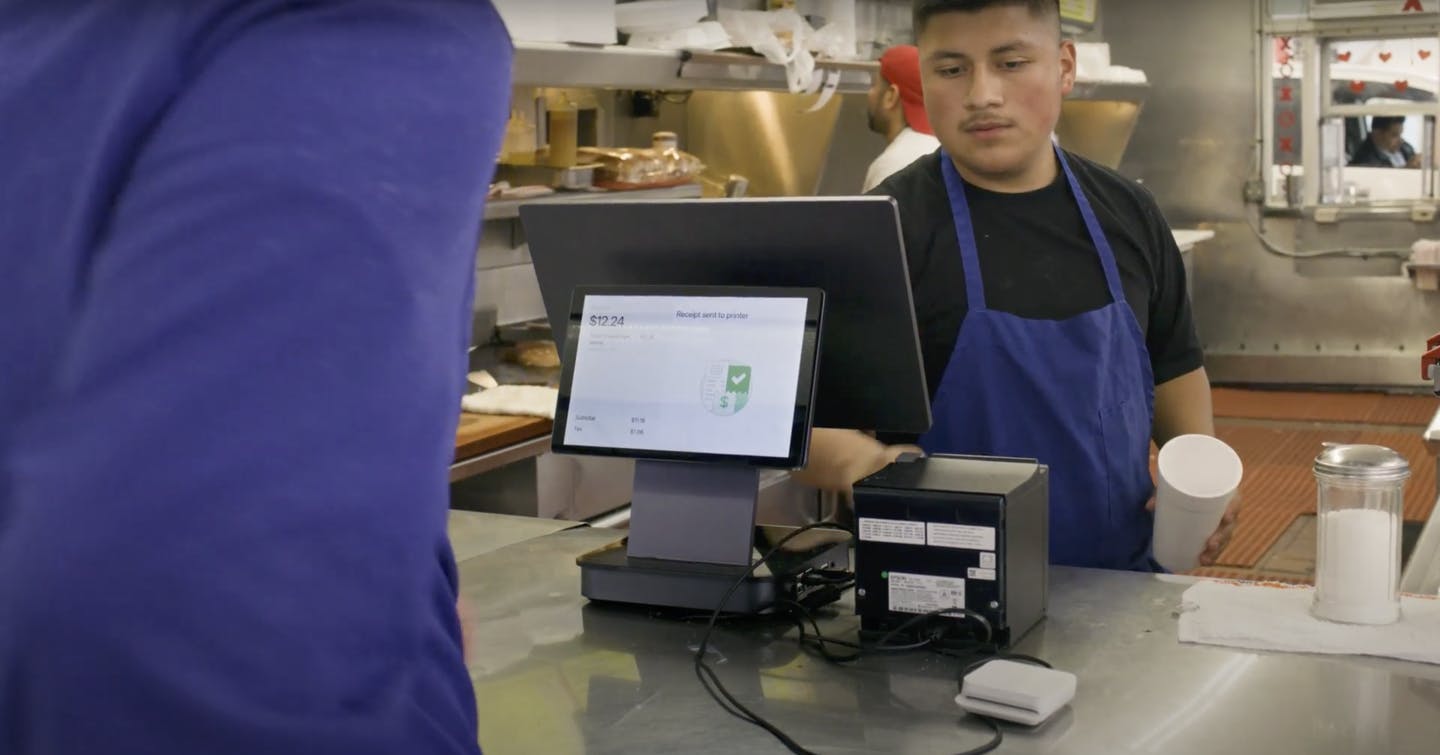 A restaurant staff member using Otter POS.