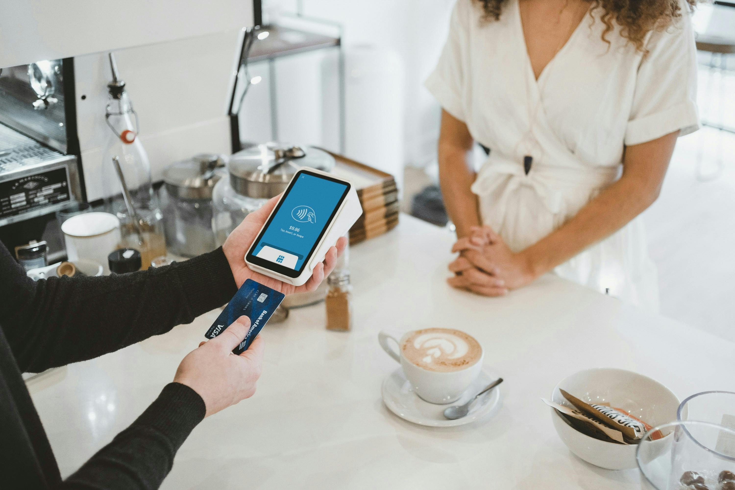 A customer using a restaurant POS system to pay for an order.