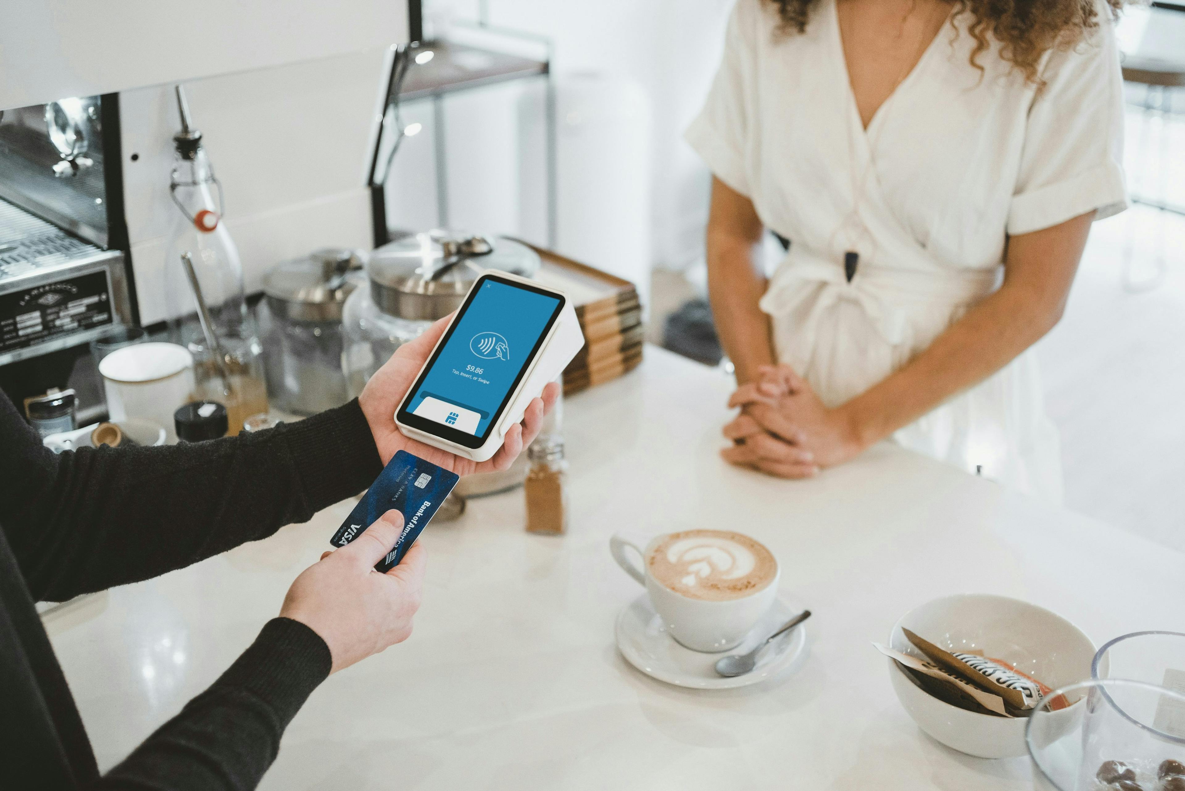 A customer using a restaurant POS system to pay for an order. 