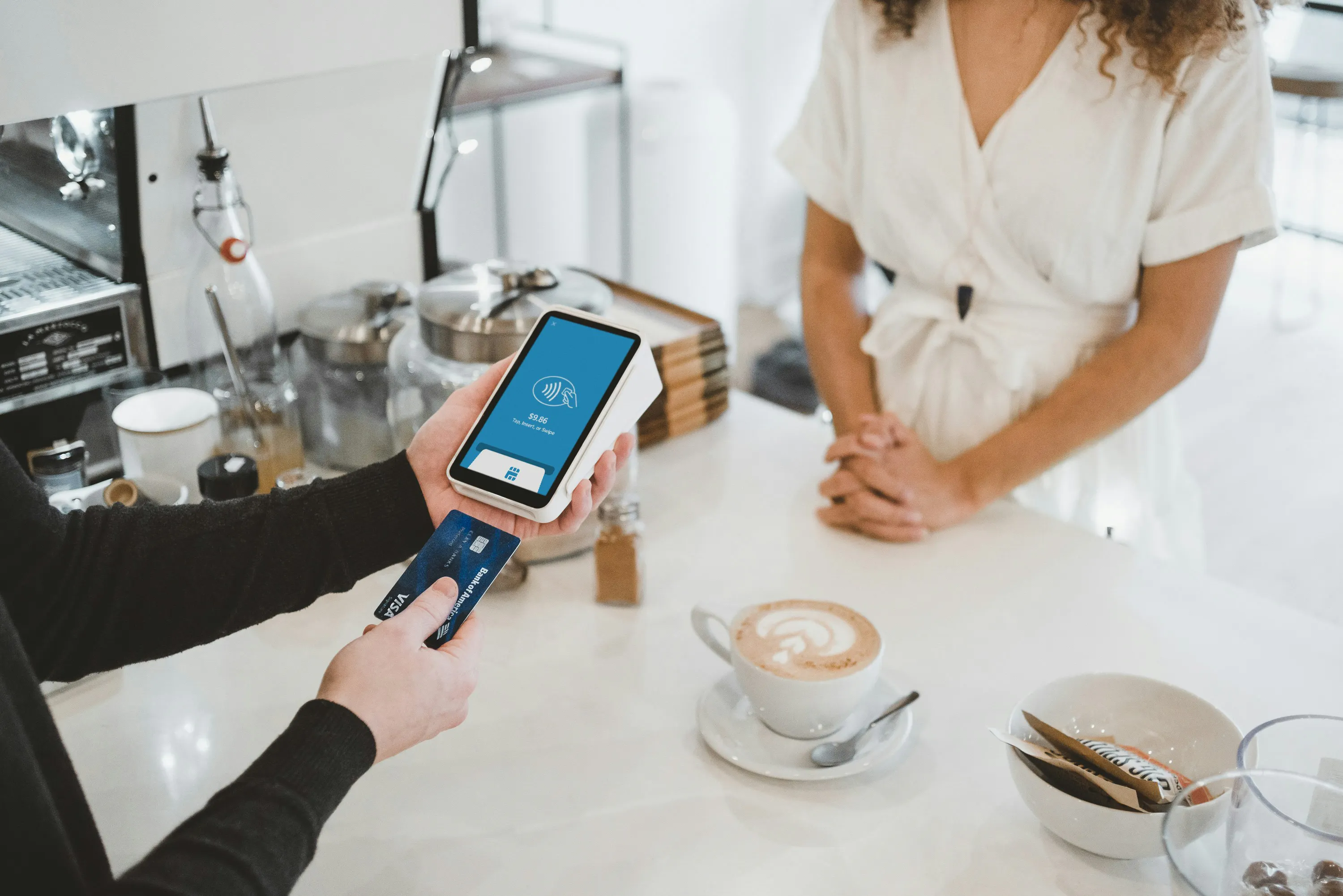A customer using a restaurant POS system to pay for an order.
