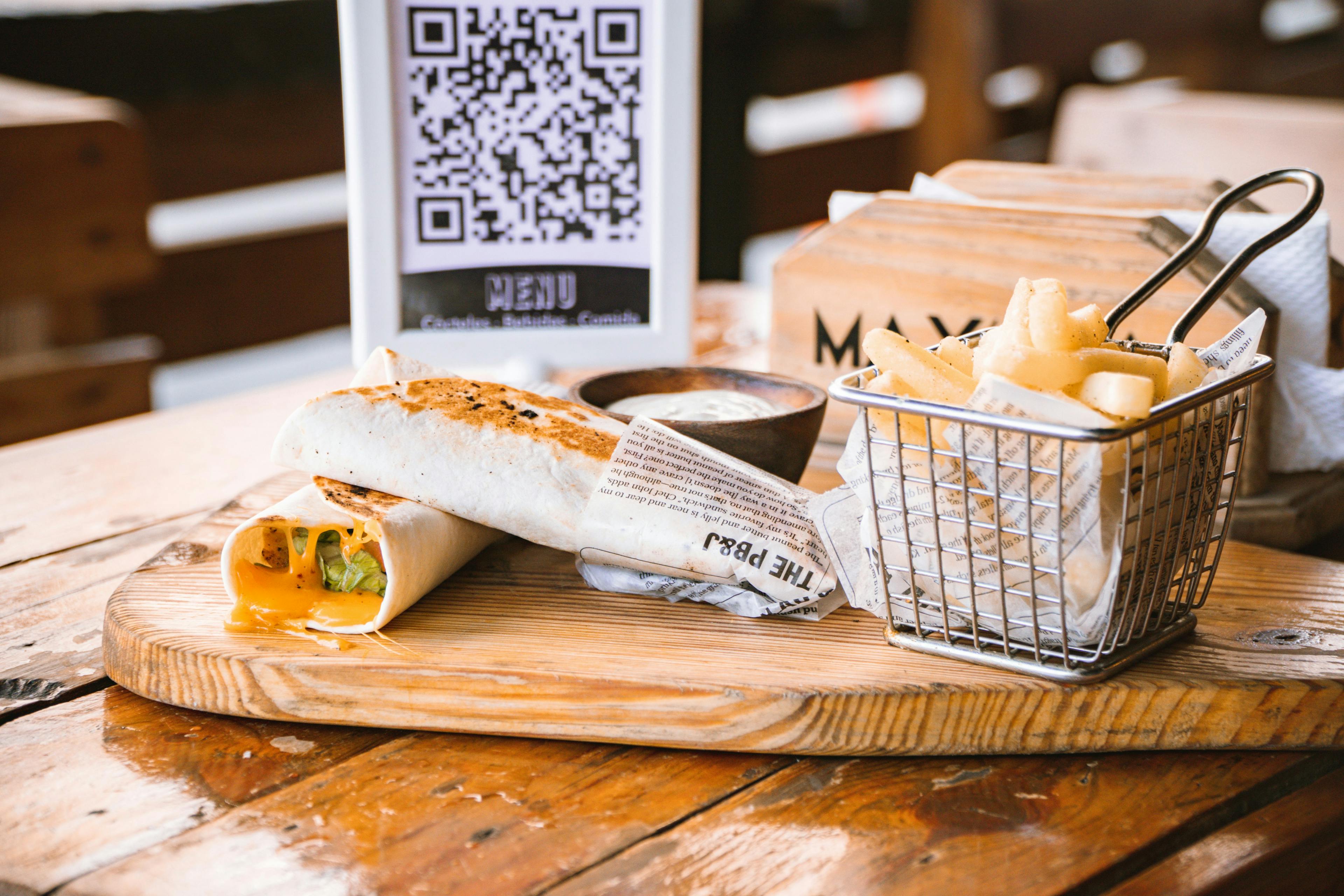 Some restaurant food next to a QR menu.