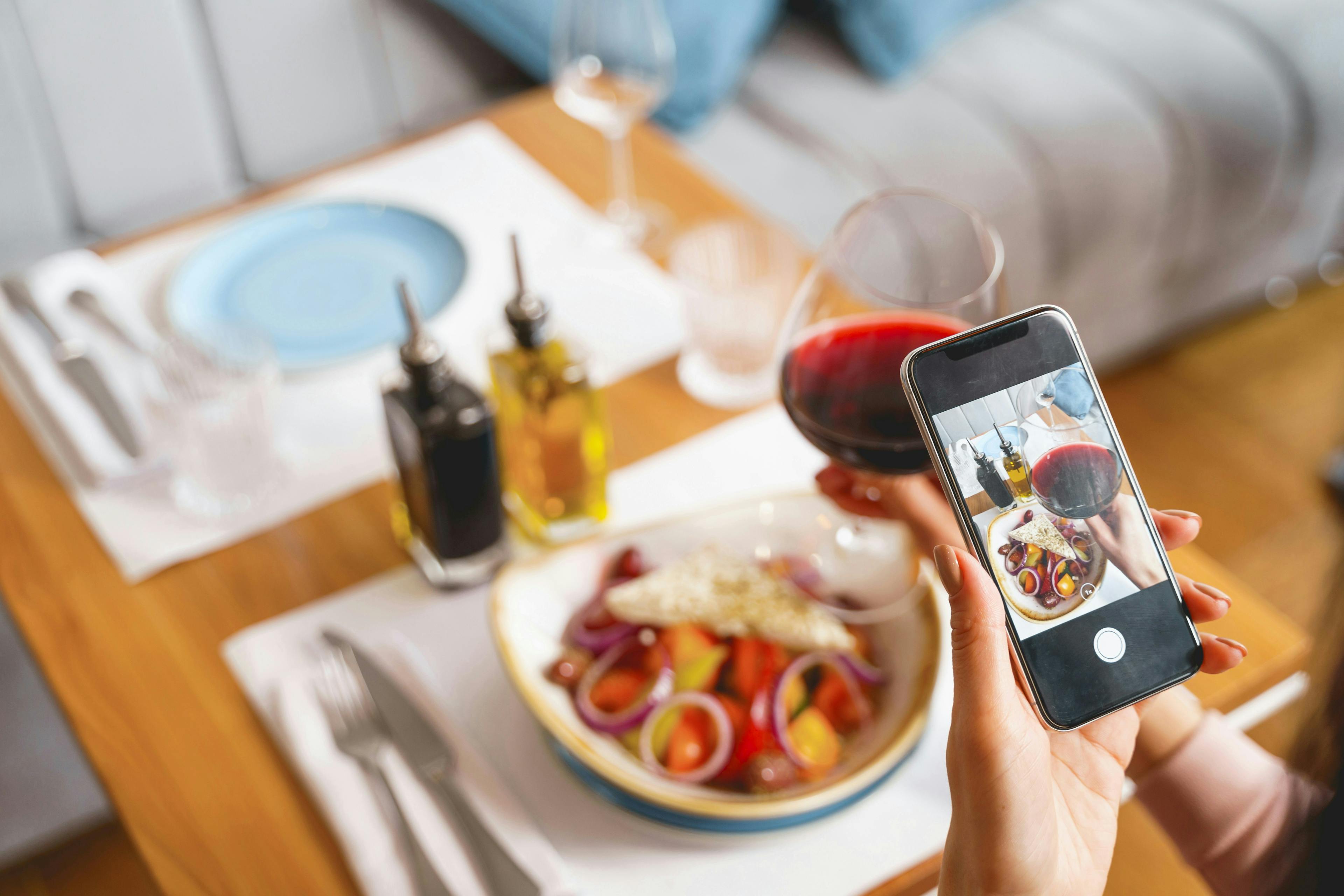 A restaurant owner taking a video for YouTube.