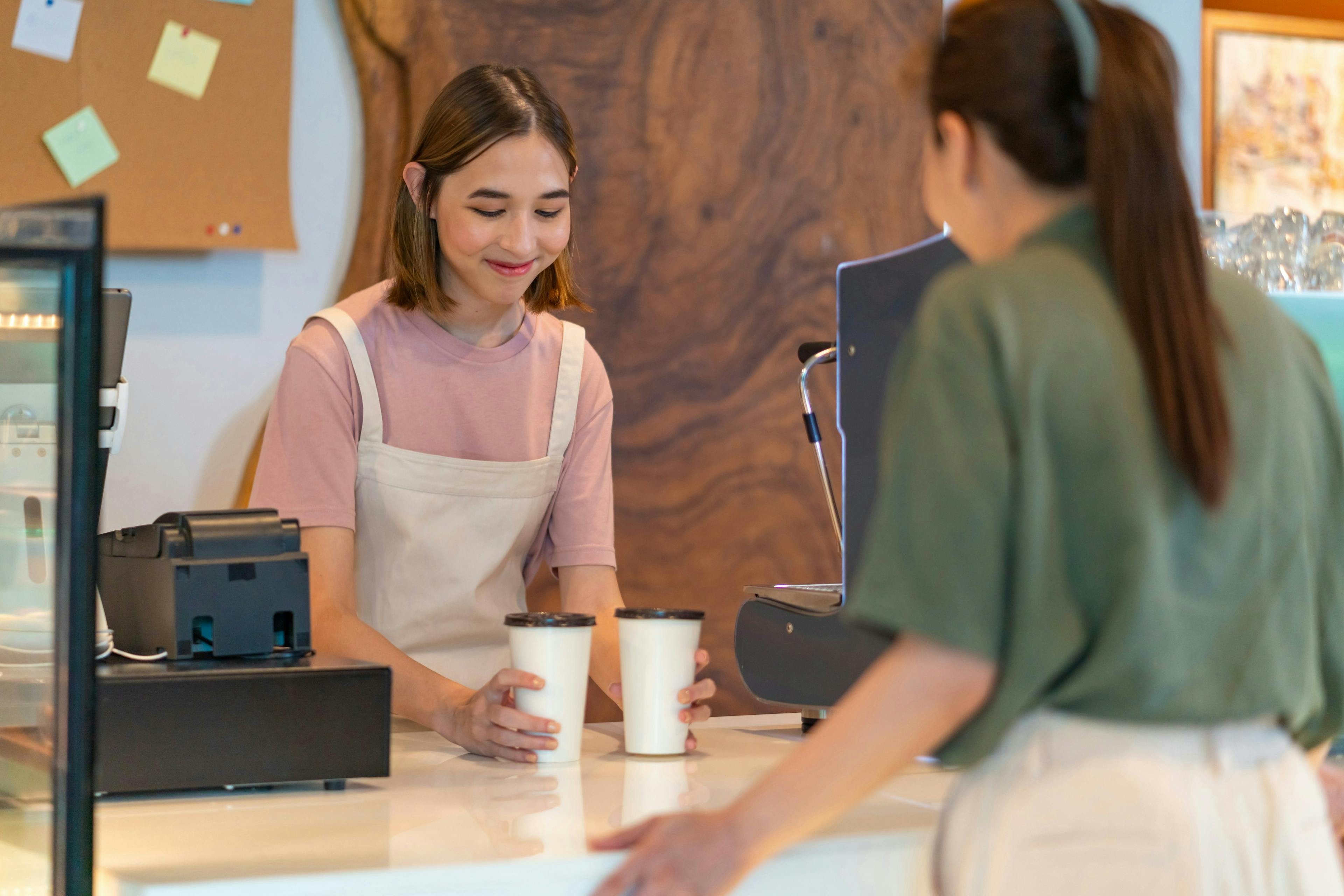 A staff member serving a restaurant order. 