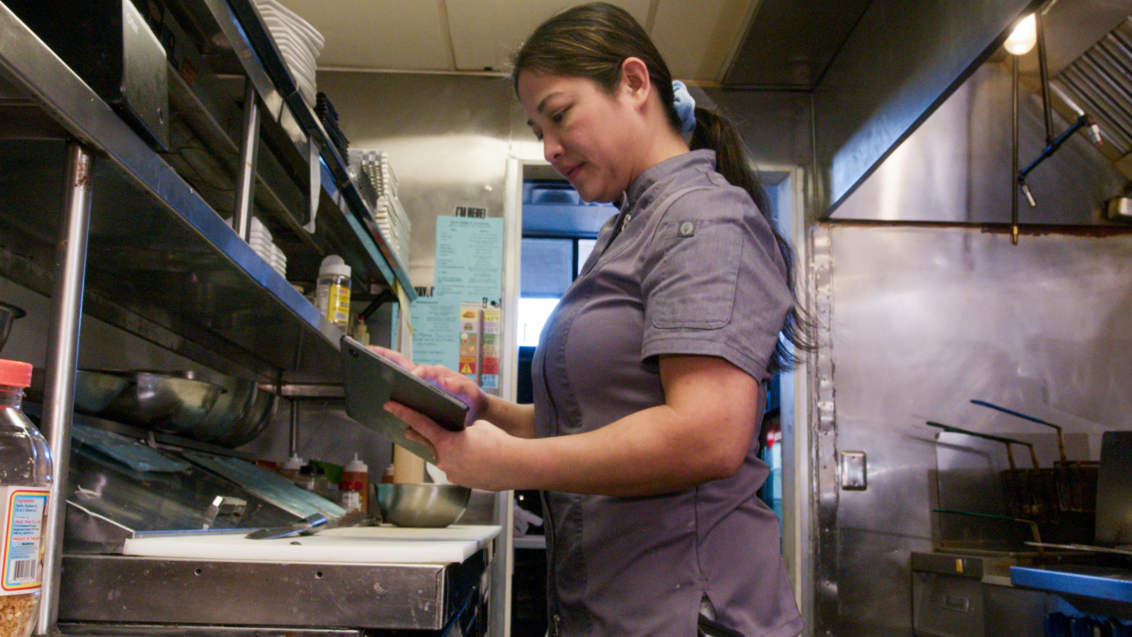 The co-owner of Lip Eats using an Otter tablet.