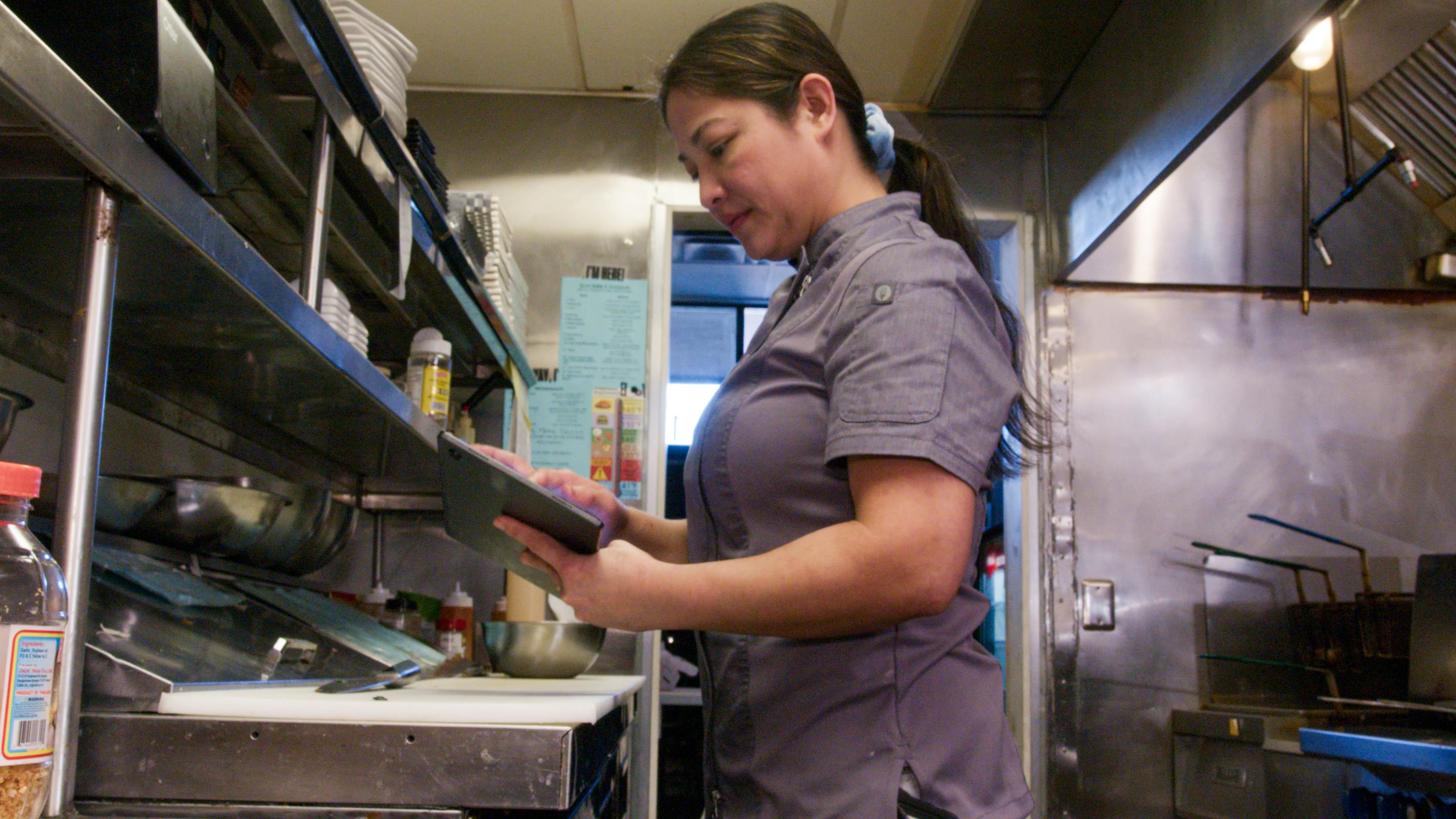 The co-owner of Lip Eats using an Otter tablet. 