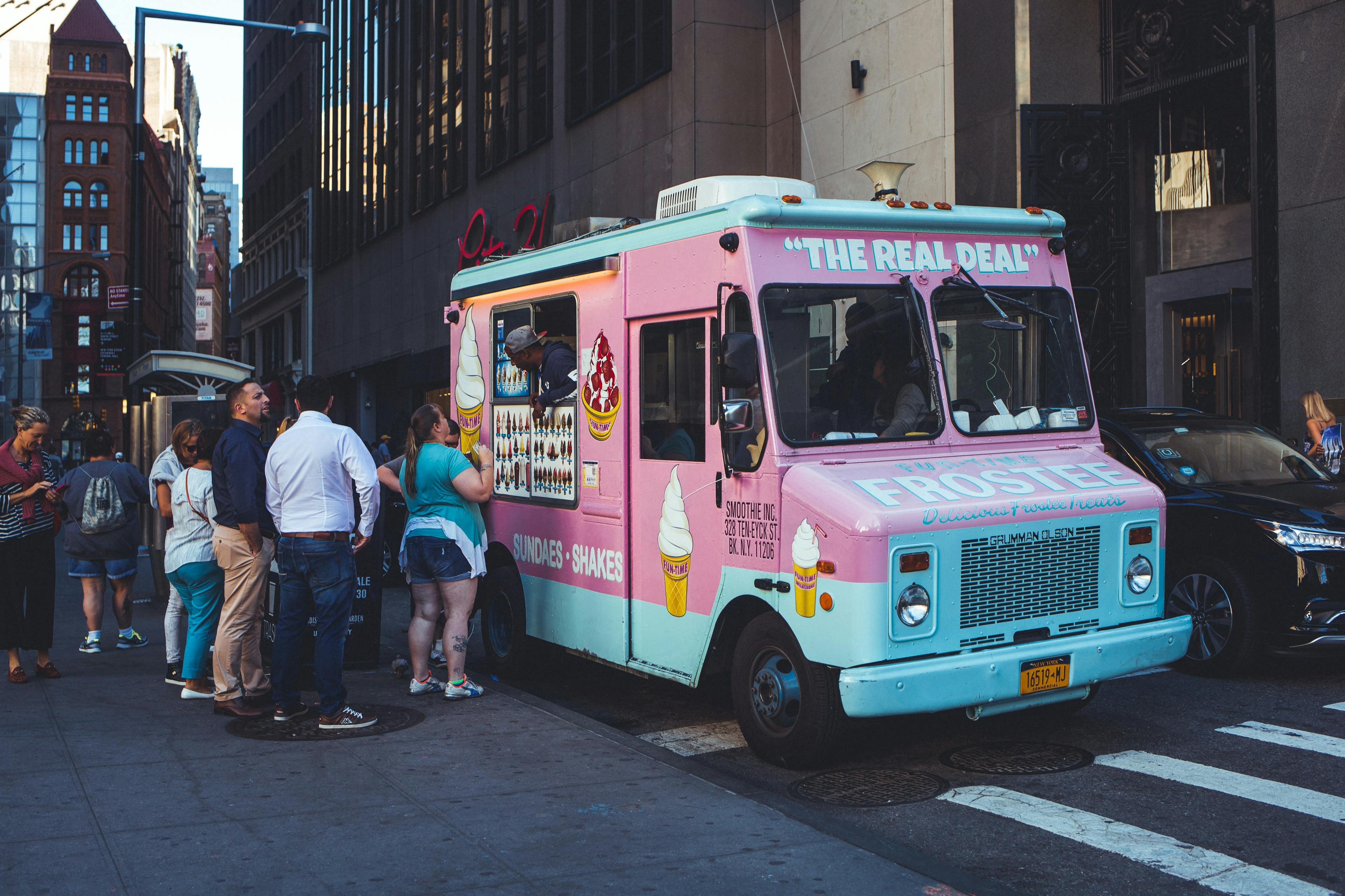 People visiting an ice cream truck in New York City, New York. 