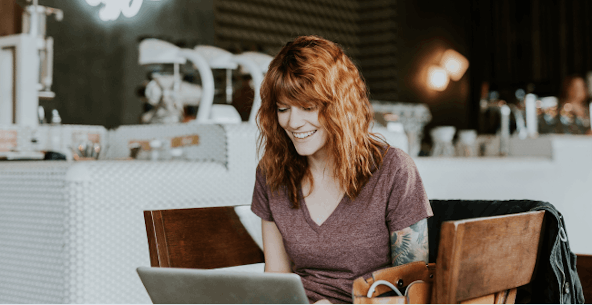 Image of a woman working on her laptop in a restaurant 