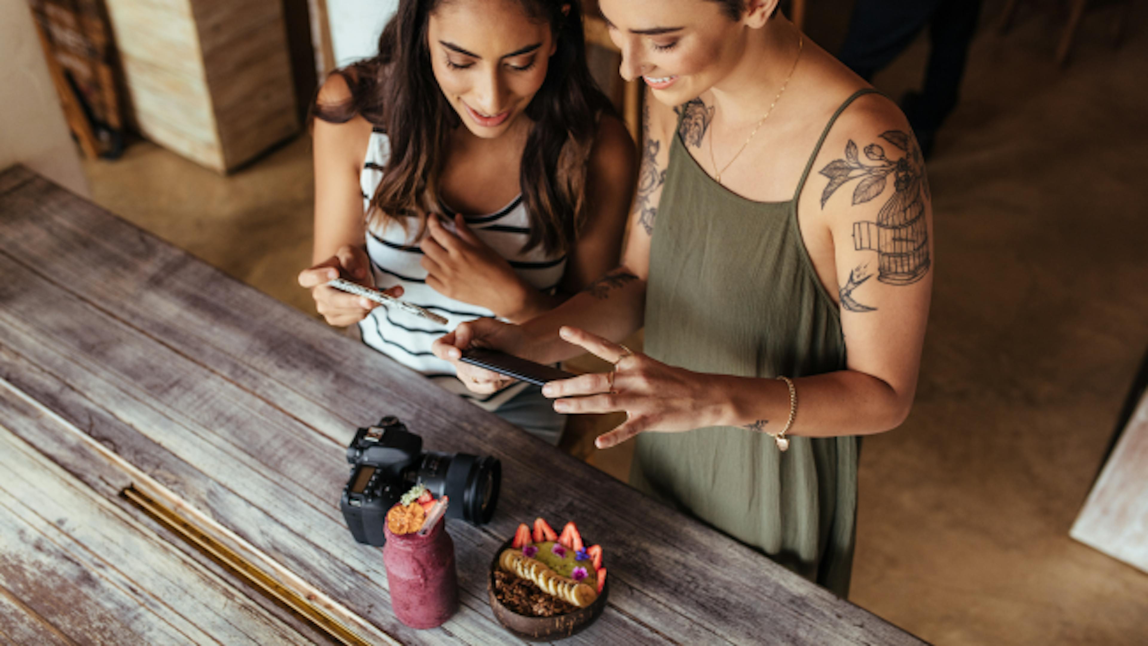 Image of two women working on their tablet in a restaurant