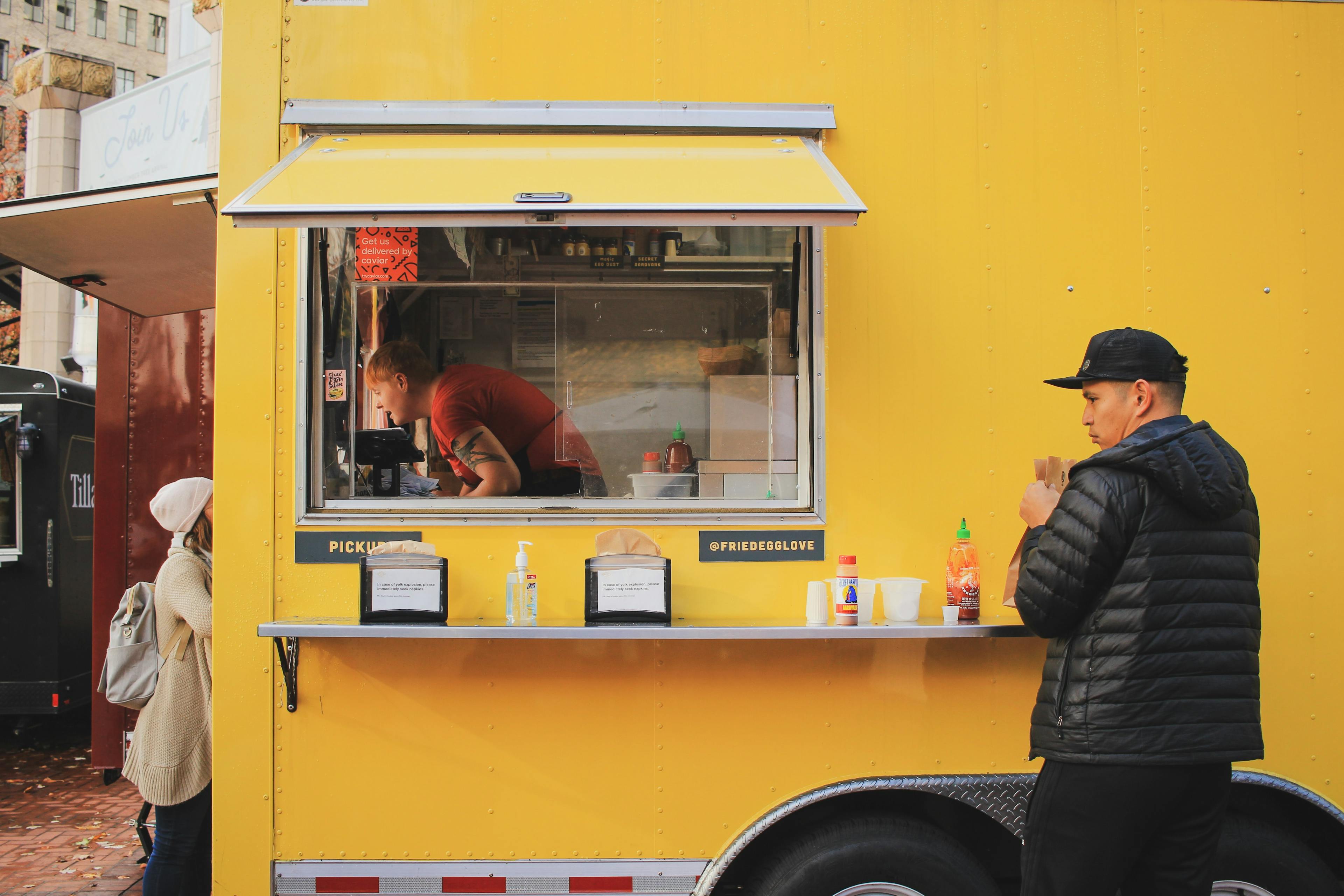 Man eating at a food truck in Portland, Oregon. 