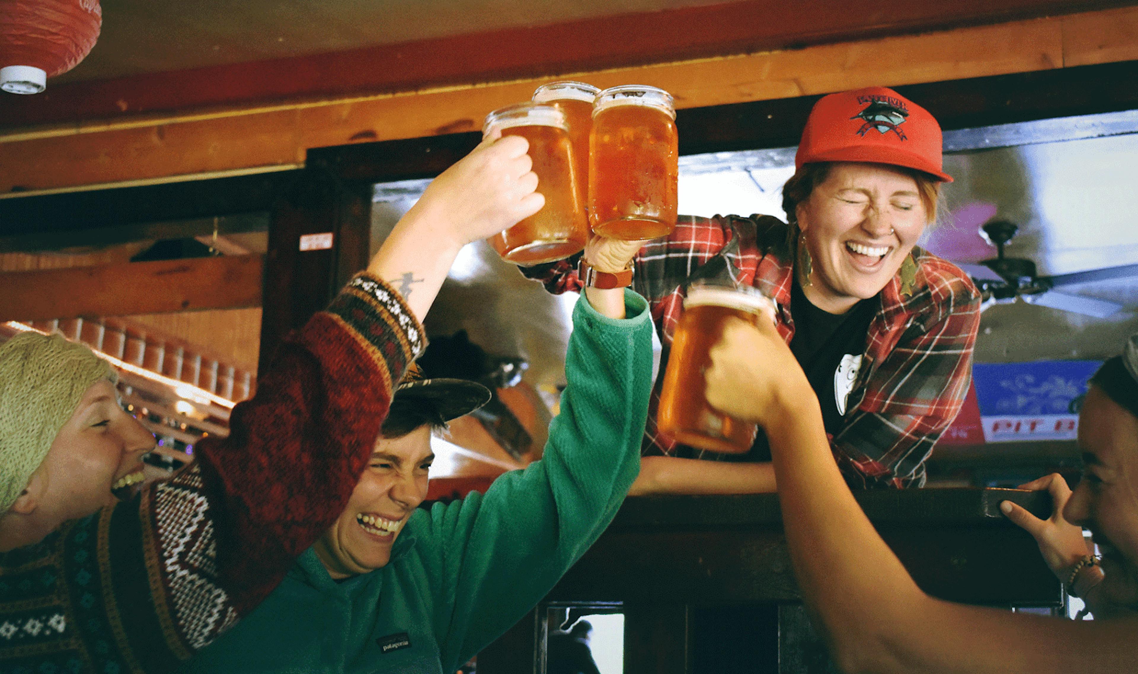 Group of three freinds cheersing glasses of beer