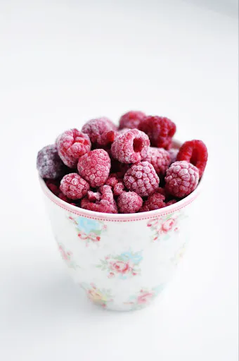 Frozen raspberries in a bowl.